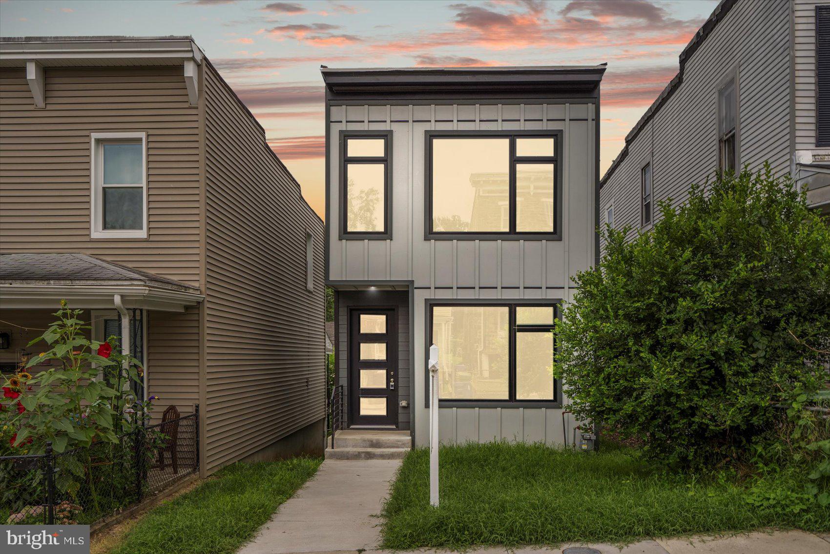 Modern elegance meets neighborhood charm in this newly constructed Hampden residence, thoughtfully designed to blend contemporary style with everyday comfort. Awash in natural light from oversized windows, the open-concept main floor showcases ¾-inch hardwood flooring and a soothing color palette, setting the tone for relaxed living and stylish entertaining. The chef’s kitchen is a showstopper, featuring sleek two-tone cabinetry (including a pantry cabinet and a walk-in pantry), quartz countertops, a stylish tiled backsplash, dual deep stainless sinks under a picture-perfect window, and a central island illuminated by pendant lighting—ideal for casual meals or morning coffee. Stainless steel appliances, including a slide-in gas range and custom vent hood, round out the space. Upstairs, three spacious bedrooms and two full baths await, including a serene primary suite with its own private bathroom. The fully finished lower level offers flexible living space—use it as a family room, guest suite, or home office—with a full bathroom, generous storage, and walk-out access to the backyard. Enjoy outdoor moments on the deck just off the kitchen, which connects directly to a rare two-car side-by-side parking pad (under construction). All this in one of Baltimore’s most beloved neighborhoods, known for its walkable streets, quirky shops, and local flavor