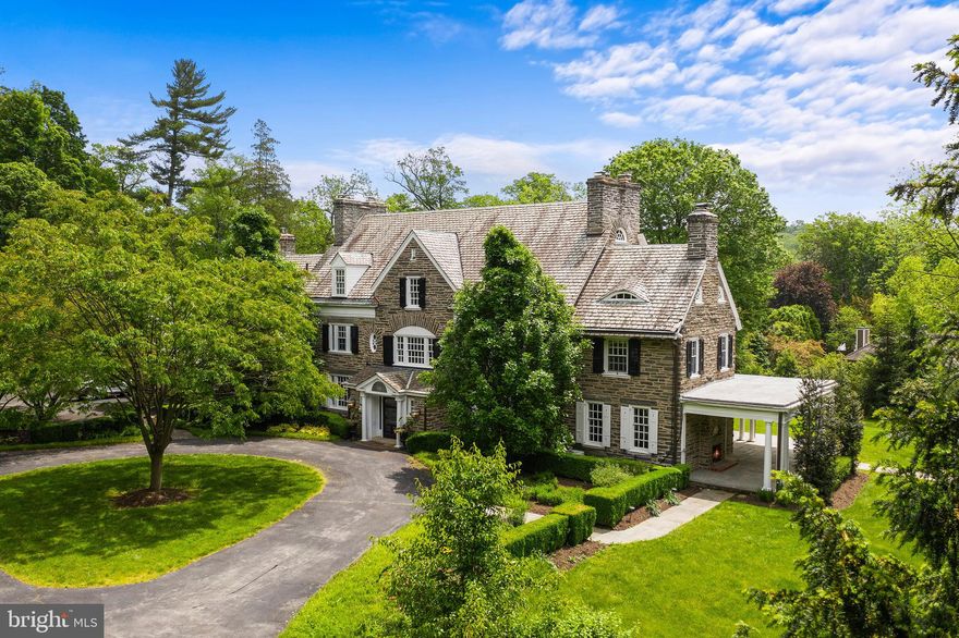 From the curved drive sits "Andorra House", a Colonial Revival estate designed by Robert McGoodwin and nestled amongst the bucolic gardens conceived by the famed Olmstead brothers. Through a courtly front door lays, an inviting center hall with views to the gardens that transitions beautifully to the home's informal and formal spaces and features a sophisticated curvilinear staircase. Thoughtful consideration has kept many original features unique to this home while managing to blend the comfort of modern updates throughout the house. The renovated kitchen offers Viking and Sub-Zero appliances, Carrara marble countertops, and radiant heated slate floors with an attached breakfast room and sizeable butler's pantry, which is perfect for hosting your china and wine collection. Off the kitchen, is an adjoining dining room for large gatherings and features a handsome fireplace. Across the hall, you'll find a family room with built-ins and French doors leading to the covered terrace and connects to a tucked-away study. Completing the first floor is two guest powder rooms and access to the four-car attached garage. Off the second floor landing, is a private master suite, with a sitting room, two fireplaces, and abundant closet space and stars a newly updated en-suite master bath. Two additional guest bedrooms with en-suite and laundry room complete this floor. The third floor has three guest bedrooms, two full guest bathrooms, and a playroom. The home also hosts a private one-bedroom apartment, home gym, and two-story bluestone portico. Conveniently located at the foot of Forbidden Drive and on over 1.6 acres, "Andorra House" is a home for those seeking to live life outdoors.