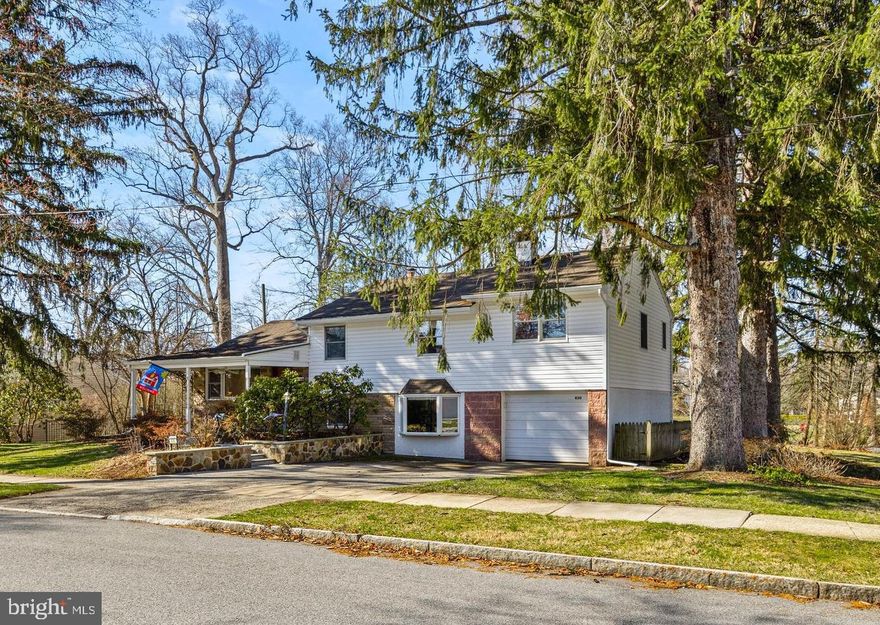 Don’t miss this expanded 4-bedroom, 2.5-bath home in the highly sought-after Garrett Hill neighborhood of Radnor Township—offering walkable access to Clem Macrone Park, Villanova University, train stations, and local dining.

A welcoming covered front porch sets the tone for this inviting home. Inside, the entry area (with coat closet) flows into a bright Living Room, thoughtfully defined by a charming vintage church pew panel, with open views to the Dining Room—ideal for everyday living and entertaining.

The updated Kitchen is designed for both function and style, featuring generous counter space and abundant cabinetry. Just a few steps down, the oversized Family Room offers a cozy retreat with a wood-burning fireplace and striking stone accent wall. This versatile space also includes a built-in bar and plenty of room for a media area, game table, or fitness zone.

The adjacent Laundry/Mudroom has been refreshed with new flooring and newer cabinetry. This level also includes a Powder Room, utility area, and convenient interior access to the oversized Garage.

Upstairs, the Primary Suite is uniquely positioned alongside the additional bedrooms—an uncommon feature in many split-level homes. The spacious suite offers multiple closets and a large ensuite bath with a jetted tub and space for a large vanity. Three additional Bedrooms share a Hall Bath with tub/shower combination. A linen closet, additional storage closet, and walk-up access to the floored attic complete this level.

Enjoy relaxing and outdoor dining on the rear patio, which overlooks the scenic yard with mature perimeter plantings, including wisteria, hydrangea, and lilac. Partial fencing provides privacy to the rear patio, and there is ample yard for gardening and recreation. The extra wide driveway provides easy parking for multiple vehicles without the need to shuffle cars.

Located in the top-rated Radnor School District, this home is just minutes from shops, movies, libraries, restaurants, and other activities in the charming towns of Bryn Mawr and Wayne. With convenient access to the Blue Route and nearby train stations, commuting to Center City, NYC, corporate centers, medical facilities, and the airport is effortless.