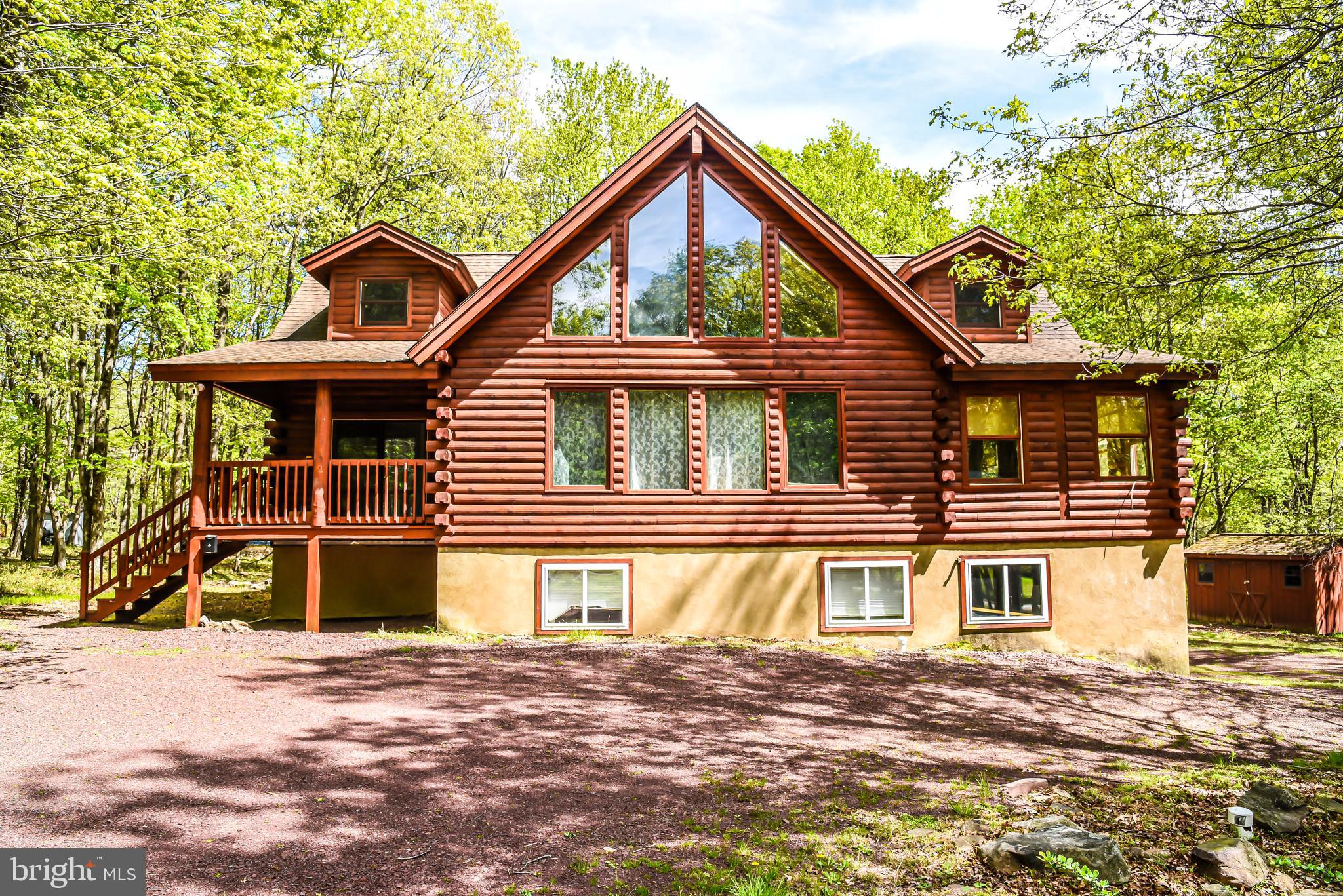 This fully furnished log home is move in ready! Spacious home with an abundance of natural light, fully finished basement with a full bath. Master bedroom suite features a full bath and sliding doors that lead to the relaxing sunroom. Enjoy the outdoors on the large deck with ceiling fans for hot summer days, hot tub for relaxation and fire pit for colder nights. Great for investment or short-term rental.
