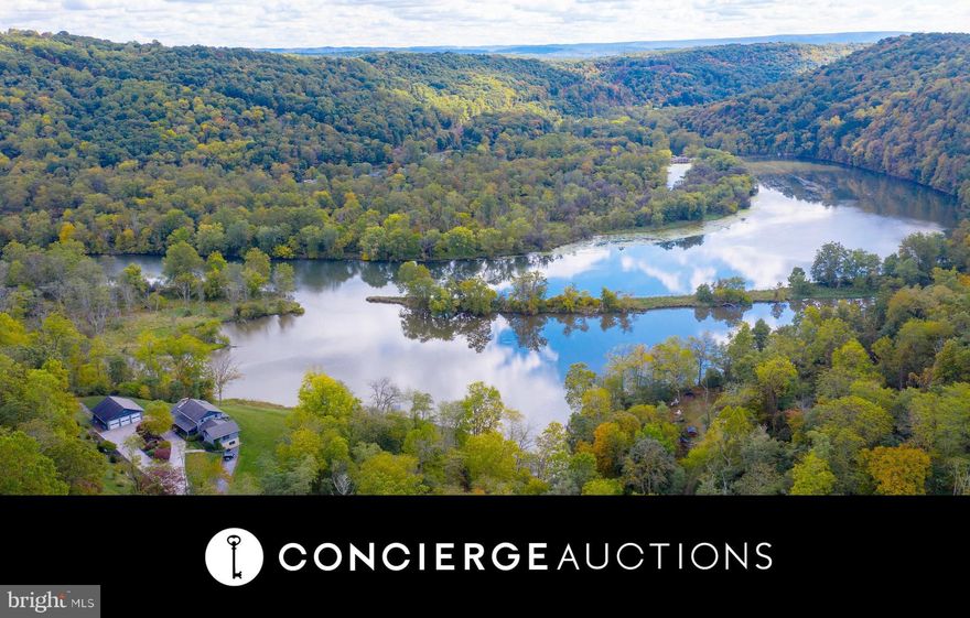 Located along the Juniata River and surrounded by rich timber, this peaceful luxurious property boasts a gorgeous log cabin residence and is completely self-sufficient. This spacious country retreat features exposed logs and beams, hardwood floors, and stonework throughout. From the open eat-in kitchen to the gorgeous living room, this home combines classic, cozy designs with modern luxury. Enjoy the sprawling views from the balcony or spend time on the water with easy access to the river from your own private dock. With 725 acres, there's plenty of room for gardening, raising livestock, or outdoor activities like boating, fishing and hunting. The state game lands on the opposite side of the river ensure the land will never be developed, and in turn, views will never be disrupted. A three-bay garage offers ample room for multiple vehicles and storage, while the detached log guest cabin offers even more living space. Set just 30 minutes from State College and Penn State University, imagine the possibilities for this ultimate retreat.