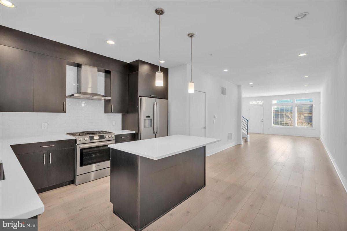 Located in Meredith School catchment, settle into Bridgeview, a gated community! This 3 bed, 3 bath home includes a roof deck with amazing views, a parking space (#55), and so much more! Stroll through the front door to unveil an exceptional open-concept living room with access to the back patio and dining area with a connected gourmet kitchen. The spectacular chef's kitchen is outfitted with top-of-the-line GE stainless steel appliances, sparkling natural stone counters, and custom European-style cabinetry. The second floor where you will find two well-appointed bedrooms fit with massive double hanging closets and accompanying spa-style bathrooms. Next, make your way to the crowning jewel of this incredible luxury town home; an expansive Primary Suite fit for royalty! Your elegantly handcrafted main bedroom suite features spacious walk-in closet with built-in shelving and an exquisite primary bathroom that leaves nothing to be desired. Spoil yourself in the custom-built open-design shower, crafted with large format European porcelain tile, river stone flooring, and dual shower heads. As if that's not enough, we have also included a full-sized finished basement for added storage and a sweeping rooftop sundeck! All square footage numbers are approximate and include above and below-grade square footage. Square footage and taxes should be verified by the buyer. Tax abatement ends 12/2027.