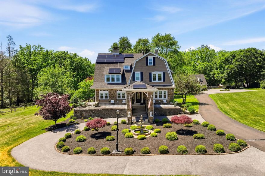 Welcome to 917 DeKalb Pike - a rare, fully upgraded stone estate offering exceptional space, privacy, and versatility on over 3.5 acres in prestigious Lower Gwynedd Township and the highly-rated Wissahickon School District.

Set well back from the road and accessed by a private gated drive, this fully fenced-in property delivers a true estate setting with the convenience of nearby major routes, regional rail, premium grocers like Whole Foods, and the vibrant dining and shopping scene of Ambler. The main residence, a classic early-20th-century stone Colonial, blends timeless architectural character with thoughtful expansions and more than $500,000 in modern upgrades.

The restored interiors showcase original hardwood floors, detailed millwork, and gracious entertaining spaces, including a sweeping formal living room with four fireplaces, expansive windows, and elegant flow between rooms. The home offers over 6,100 total square feet of living space (4,941 above grade plus a finished basement) with seven bedrooms and multiple flexible-use areas ideal for today's needs, whether for remote work, creative studios, or multi-generational living.

At the heart of the home, the expanded chef's kitchen features custom soft-close cabinetry, a massive center island, granite countertops, a farmhouse sink, high-end smart appliances, and a walk-in pantry with custom shelving, seamlessly connecting to both indoor and outdoor living areas. Multiple renovated bathrooms, including a spacious primary suite featuring a double vanity, bidet, and expansive double shower with a bench, provide modern comfort while preserving the home's character.

Beyond the main house, the estate truly distinguishes itself. A detached studio-style guest cottage with a full kitchen and bath is perfect for use as a pool house, an Airbnb, au pair housing, or more! What's more, a substantial 3-car detached garage offers owners and guests plenty of undercover parking along with an 8-vehicle parking lot, as well as room for storage, and the large second floor above is ready to be finished. The expansive grounds open the door to a wide range of possibilities, whether for extended family, guest accommodations, a home business, or future customization. The outdoor environment is designed for both relaxation and elite entertaining, featuring a fully upgraded saltwater pool with tanning ledge, waterfall, and slide, along with a brand-new hot tub and gazebo, outdoor kitchen,built-in fire pit, and recreation areas including bocce and horseshoe courts. The setting offers a private, resort-like experience rarely found in this location.

Extensive recent improvements provide peace of mind and long-term efficiency (and massive utility savings), including a new 50-year roof, 54 brand-new windows, air conditioning, updated electrical with complete removal of knob-and-tube wiring and a whole-home surge protector, new cedar impression siding and gutters, and a whole-home water filtration system. A 72-panel solar array was installed in 2022 and delivers a peak output of 25.92 kWp (significantly lowering your electric bill), complemented by underground electrical service for enhanced reliability in our changing times. In 2025, the home was further upgraded with a new high-capacity natural gas heating system, replacing the original oil furnace system. Other updates and repairs, including chimney restoration and interior refinishing, reflect the consistent care and investment the owners have lovingly put into their home.

With its combination of historic charm, modern infrastructure, expansive grounds, and multiple auxiliary structures, 917 DeKalb Pike offers a unique opportunity to enjoy a turnkey estate immediately while still providing the flexibility to tailor the property to your vision over time.