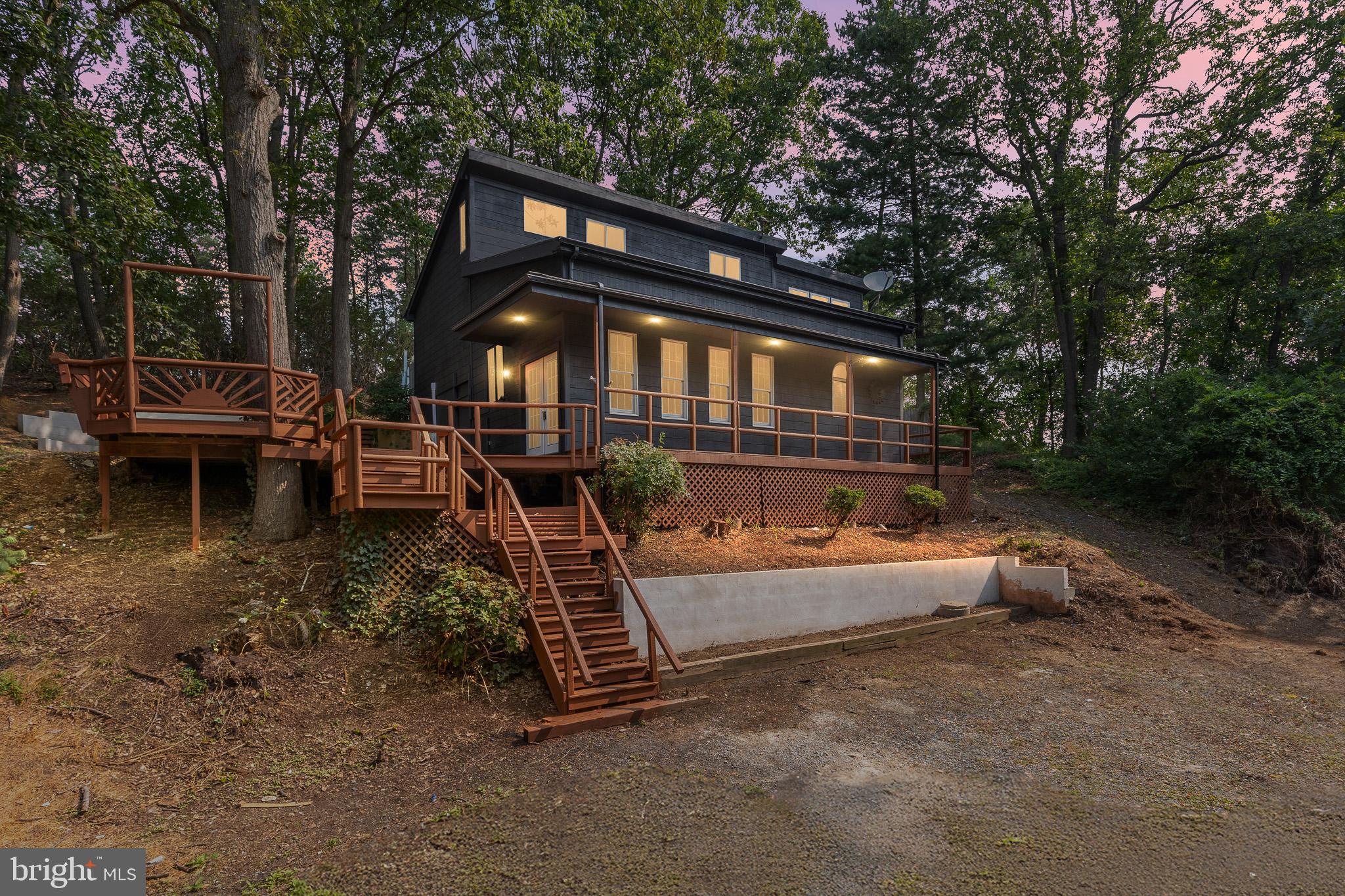 Experience the perfect blend of modern design and rustic elegance at this fully remodeled cabin retreat, set on over an acre of secluded, wooded land. From the moment you arrive, the setting offers a sense of peace and privacy, with mature trees framing a home bathed in natural light and finished with thoughtful, high-quality touches throughout. The expansive outdoor living area is a true showpiece. A massive deck with a serene water feature, paired with a cozy fire pit for evening gatherings under the stars. With ample parking for a camper, boat, or multiple guests, this property is ready for both entertaining and adventure. Two versatile sheds provide exceptional flexibility, including one with full electrical service, ideal for a private home office, creative studio, or workshop. Perfect as a primary residence equipped with 3 Bedrooms and 2.5 Baths with an added bonus room flex space. This home offers unmatched convenience with quick access to Elkton, local shops, dining, and I-95. Just minutes from the water, it's also a dream vacation escape, allowing you to enjoy fishing, boating, and water leisure at a moment's notice. Whether you're seeking a tranquil full-time home or a stylish weekend retreat, this move-in-ready property delivers comfort, functionality, and beauty in every detail.