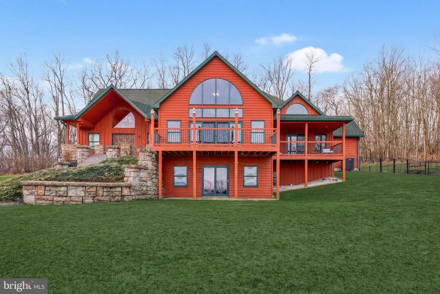 Tucked at the end of a cul-de-sac on over 4 scenic acres, this one-of-a-kind cedar- and stone-sided contemporary home offers more than 4,300 square feet of beautifully crafted living space. Featuring 4 bedrooms and 4.5 bathrooms, the home showcases an open, sun-filled layout with cathedral wood ceilings, exposed beams, and rich wood floors throughout. The expansive country kitchen with granite countertops flows seamlessly into the dining area and inviting sunroom—perfect for enjoying peaceful wooded views. The dramatic living room features a vaulted ceiling and striking stone fireplace, while the main-level primary suite offers vaulted ceilings, a spa-like bath, and direct access to outdoor living. A convenient first-floor laundry adds everyday ease. Upstairs, a charming loft with built-in bookcases creates the perfect library or flex space overlooking the main living area. The finished lower level is designed for both relaxation and entertainment, complete with a family or exercise room with wood stove and a multi-level theater/media room. Step outside to enjoy the private setting, complete with a sauna nestled in the yard—your own retreat-like escape. Additional highlights include oil hot water baseboard heat with heat pump backup (two zones), wiring for security and fire alarm systems, and a detached 30' x 50' garage/storage building. With 40-year shingles on both the home and outbuilding and exceptional craftsmanship throughout, this extraordinary property offers privacy, quality, and a true connection to nature.