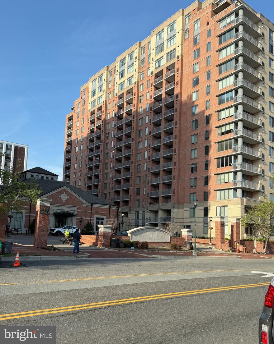 Welcome to The Gallery, a highly desirable building and neighborhood. Conveniently located near major shopping and restaurants, it's across the street from Pike and Rose! You can walk to the North Bethesda Metro stop. It's also close to Harris Teeter or Wegmans grocery stores, as well as just minutes away from the Gourmet Giant and Rockville Pike's largest open-air shopping area.

This unit features an open floor plan that is spacious and bright thanks to an oversized balcony allowing plenty of air and light in. Enjoy brand new beige wide-planked engineered vinyl floors throughout. The large bedroom has a generous closet with shelving, along with a recently updated bathroom featuring new light fixtures, mirrors, hardware, and refinished tub.

The kitchen boasts newer stainless appliances, refinished cabinets, all installed 2-3 years ago. For added convenience for residents, there is a stack washer/dryer in the kitchen area. Fresh paint covers the entire unit; the seller has taken care of everything for the lucky future buyers.

The building offers various amenities for residents such as a workout room, pool, library, and clubhouse for entertainment purposes. This premium 13th-floor unit faces towards the interior of the subdivision without any noise from Rockville Pike traffic while providing breathtaking distant views of both