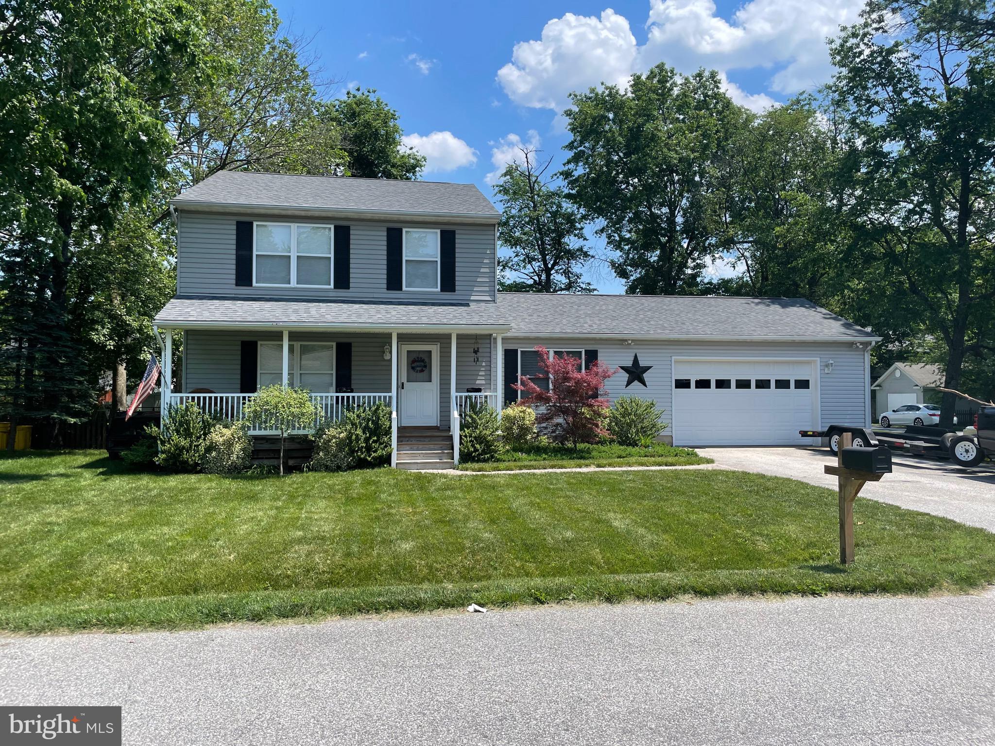 Coming Soon! This beautiful, porch front, Colonial style home is move in ready! The updating has already been done just pack your bags and move right in! Stay tuned for more information and photos to follow! Showings start 6/9. Make your plans now, this one will go quick!!
This gorgeous single family home will wow you from the moment you drive up. The lawn has been impeccably maintained and the lot is just over 1/4 acre! The porch front Colonial style home offers fresh, neutral paint throughout and Luxury Plank flooring on the main level as well as in the upper level baths and master bedroom. The kitchen was completely remodeled in June of 2020 with fingerprint resistant (thank goodness!) stainless steel appliances, gorgeous granite countertops, Peerless pull down faucet and stainless steel sink. White cabinetry finish this beautiful kitchen off perfectly! The main level features a living room that flows right into the dining room with a slider to the spacious rear deck for entertaining. A half bath and a main level family room that includes a walk in closet ,which could allow this space to convert to a main level bedroom space if you ever needed it, finish out the main level offerings. Upstairs you will find a beautiful master suite with a walk in closet and a spacious full bath including a lovely soaker style tub and separate shower as well as dual sinks. The master suite also features Luxury plank flooring. The upper level also includes two additional bedrooms and a full bath off the hallway. The lower level of this gorgeous home offers a family room the utility/laundry room and a possible fourth bedroom with a closet and the walk out to the rear yard. The final piece to this gorgeous property is the oversized, over 500 square feet, two car garage. The garage also has a door that walks out to the rear yard for convenience. The roof was replaced in May of 2017 with Architectural shingles, the dual zone HVAC's were replaced with 16 seer Heat Pumps for efficiency in September of 2018 and the water heater was replaced in July of 2019. The carpet on the stairway and upper level was replaced in June of 2020 as well as the electric outlets and switches on the main and upper levels, the door and cabinet hardware and all lighting and ceiling fans. This beautiful home is move in ready and waiting for its next owner to love it as much as this original owner has, Welcome Home!