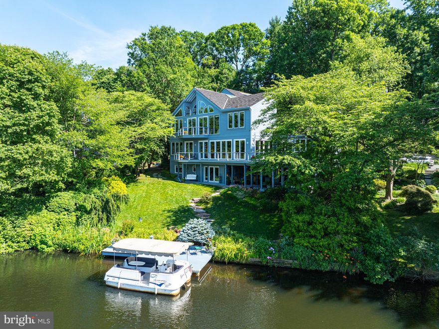 Yes! The premiere waterfront home in Reston is now available for sale! This is a rare opportunity to become the new owner of this stunning custom contemporary on Lake Audubon. Get ready to enjoy sweeping, 180-degree+ views of "big water" from 3 decks & throughout the home. This exquisite home offers ample living space, inside & out. With 4 bedrooms & 5 full baths plus a powder room, coupled with comfortable living spaces, this home is ready to provide everything you are looking for in a waterfront home. From the moment you step inside, you will notice how spectacular the setting is. This home has been meticulously maintained & features custom millwork, granite floors, marble floors & hardwoods. Gorgeous Pella & Andersen windows & sliding doors, atrium windows, & Velux skylights provide beautiful natural light & amazing views. The kitchen has granite counters, a vaulted ceiling, high-end appliances & opens to the main living area. The open floor plan in the main living area is great for entertaining, & the dining room has walls of sliding glass doors leading to the main level deck which extends the length of the house. You will love the unobstructed views of the lake throughout the year. The main level has a bedroom with an en suite with access to the main deck. The primary suite is on the upper level & offers luxurious amenities with heated marble floors throughout the suite, plus lush carpet around the built-in bed. Gorgeous built-ins with LED lighting, a vaulted ceiling, walls of windows & sliding glass doors leading to a private deck with commanding views of the lake are ready for you to enjoy. The primary bath has a separate tub & steam shower - both with lake views! Double doors open to the walk-in closet with ample space & built-ins. There is a loft overlooking the primary suite which is a perfect office with custom built-ins. There is also an additional private office on this level. Need extra space for an au pair or in-law suite? You'll find it here - complete with a living area, dining area, full kitchen with high-end appliances, quartz counters, & a private bedroom & en suite. The upper level features the media room-great for movie night. The lower level has great space for casual entertaining. The family room was recently remodeled & has a sliding glass door to the lower-level deck. There is also a recreation room with a sliding glass door leading to the deck, private dock & lake. The fourth bedroom with an en suite is on this level as well. There is a small kitchen next to the rec room with refrigerator drawers, a wine refrigerator, Miele dishwasher & 2-burner cooktop - perfect for quick snacks & drinks on the deck or boat. Awesome outdoor space with beautiful hardscaping & landscaping, & 2 main decks which connect via the side stairs. The covered lower deck features a gas firepit table, ceiling fan & a hot tub. Plus, you have your own private dock & pontoon boat! New synthetic roof! Finished 3-car garage connects to a workshop. Heated driveway! Irrigation system. MOST FURNITURE CAN CONVEY. LOCATION: Amazing Reston location! Enjoy launching your pontoon boat from your private dock, paddleboarding, kayaking, canoeing, and fishing! COMMUNITY:  1.2 miles to South Lakes Shopping Center-with Safeway, CVS, and local favorite spots - Red's Table and Cafesano (dining), & more! Close to major commuter routes with easy access to the Dulles Toll Road at the Reston Parkway, Wiehle and Hunter Mill exits. The Wiehle Ave. Metro Station is just 2 miles away! Dulles Airport is less than 10 miles away. Enjoy the miles of paths and trails Reston offers, as well as other trails it easily connects to, including Twin Branches Nature Trail, the W&OD Trail and the Cross County Trail! Enjoy Reston amenities including the pools, tennis courts, the Reston Community Center, Walker Nature Center, arts programs & more! Enjoy waterfront living on Lake Audubon every day! CLICK ON THE VIDEO ICON, CLICK ON MENU, THEN CLICK VIDEO FOR 2 VIDEOS!