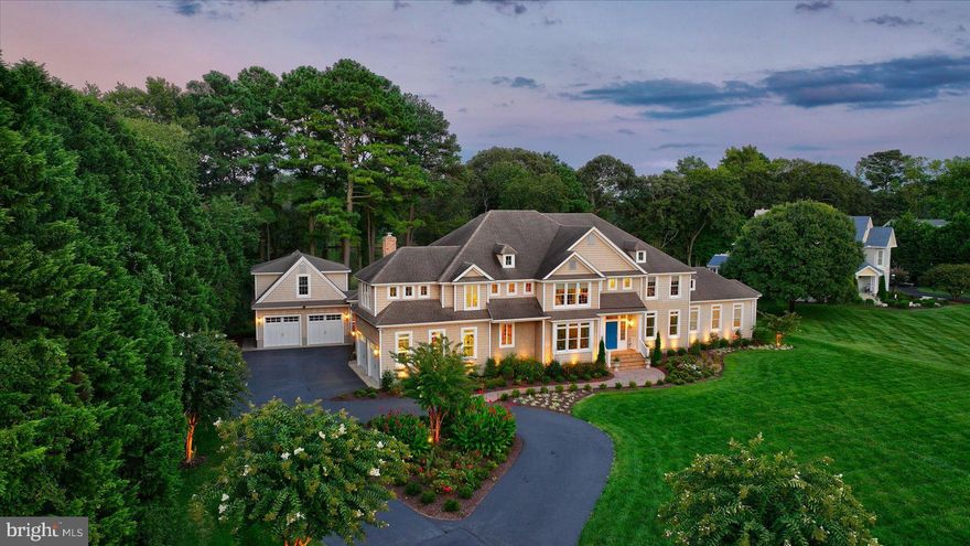 Waterfront Estate | Headwaters of the Shingle Landing River | Positioned on over two private waterfront acres at the headwaters of the Shingle Landing River, this exceptional custom residence by White Creek Homes, Inc. embodies refined coastal living at its finest. Encompassing over 7,000 square feet, the home offers 6 bedrooms, 5 full baths, and 1 half bath, thoughtfully designed to balance architectural presence with everyday comfort. A sweeping approach framed by professional landscaping and curated hardscapes sets a distinguished tone. Beyond, your private dock invites effortless days on the water—boating to nearby waterfront restaurants, fishing at sunrise, or enjoying peaceful afternoons kayaking along the river. Inside, the architectural flow is intentional and elegant. The foyer introduces gracious formal and informal living spaces, including a formal dining room, a refined living room with fireplace, and a separate sitting room anchored by its own fireplace. Expansive windows frame serene water views throughout. The main-level primary suite is a private sanctuary featuring panoramic river vistas, a spa-inspired bath with soaking tub and glass-enclosed tiled shower, a dedicated dressing room, and generous walk-in closets—offering a five-star retreat experience at home. The kitchen reflects both craftsmanship and performance, appointed with Sub-Zero and Wolf appliances, custom cabinetry, and seamless connectivity to a sunlit breakfast room overlooking the water. An adjacent fireside gathering space creates an inviting setting for relaxed mornings and intimate evenings. The second level is thoughtfully configured for both privacy and functionality, offering two en suite bedrooms, two additional bedrooms connected by a Jack-and-Jill bath, and a fifth bedroom serviced by a full bath located just off the private fitness studio. A dedicated laundry room enhances convenience on this level. The third floor provides an additional family retreat with access to a private rear deck overlooking the waterway—an elevated vantage point for quiet reflection or relaxed entertaining. Outdoor living is equally compelling, with expansive hardscapes, integrated gas grill, and fire feature creating a resort-style terrace designed for refined gatherings. A detached garage with unfinished bonus space above offers flexibility for guest quarters, studio, or executive workspace.  Ideally located, the property offers convenient access to the charm and fine dining of Berlin, the beaches and boardwalk of Ocean City, and the coastal lifestyle of Fenwick Island. Regional and private air travel is easily accommodated via Salisbury Regional Airport, making this estate as accessible as it is private. This is not simply a home—it is a private waterfront estate curated for those who value craftsmanship, discretion, and an uncompromising coastal lifestyle.