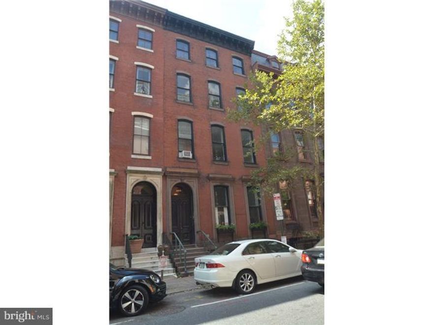 Grand Spruce street property, steps from Rittenhouse Square, lot size: 24' x 117 ', over 7300 sq ft with high ceilings, wood wainscoting, moldings, multiple ornamental fireplaces. Grand stair with wood balustrades and leaded glass skylight.  1st floor front: Living rm and Bedroom both w/ornamental frpls w/ marble mantles, tile Bath, Galley Kitchen, oak flrs. 1st floor rear, wood wainscoting in entry hallway, entry closet, Bath w/ classic tile, Living Rm w/oak flrs, molding, wood mantle on ornamental frpl and wood wainscoting, rear Bedroom. 2nd floor front: Hallway w/ wood wainscoting, Bedroom and Living both w/ marble mantles on ornamental frpls, oak floors, tile bath. 2nd floor rear: entry closet, Bath w/ classic blue and yellow tile, wood wainscoting in entry hall. Carpeted Living rm and Bedroom, Galley Kitchen, wood mantle on Living Rm ornamental frpl, Bedroom with leaded glass window. 3rd floor Rear: entry with lge closet, Bath, Living Rm with wood mantle and tile face on double ornamental frpls, Living rm and Bedroom carpeted. 3rd floor front: Bi-level former owner's unit. wide Entry hallway with closets and Powder rm, Living Rm w/ recessed lights, marble mantle on ornamental frpl, pine flrs, Dining rm w/recessed lights, wood mantle on ornamental frpl, pine flrs, Kitchen w/slate floor,painted wood cabinets  elegant stair to the 4th floor front: main Bedroom with private Bath w/ shower, walk through closet, clerestory windows, Hall tile Bath and washer/dryer closet.  Two additional Bedrooms.  Pine floors throughout. Bi-level unit has separate central air.  Building has oil fired hot water heat. Tenants pay electric. There is a coin washer/dryer in the basement.