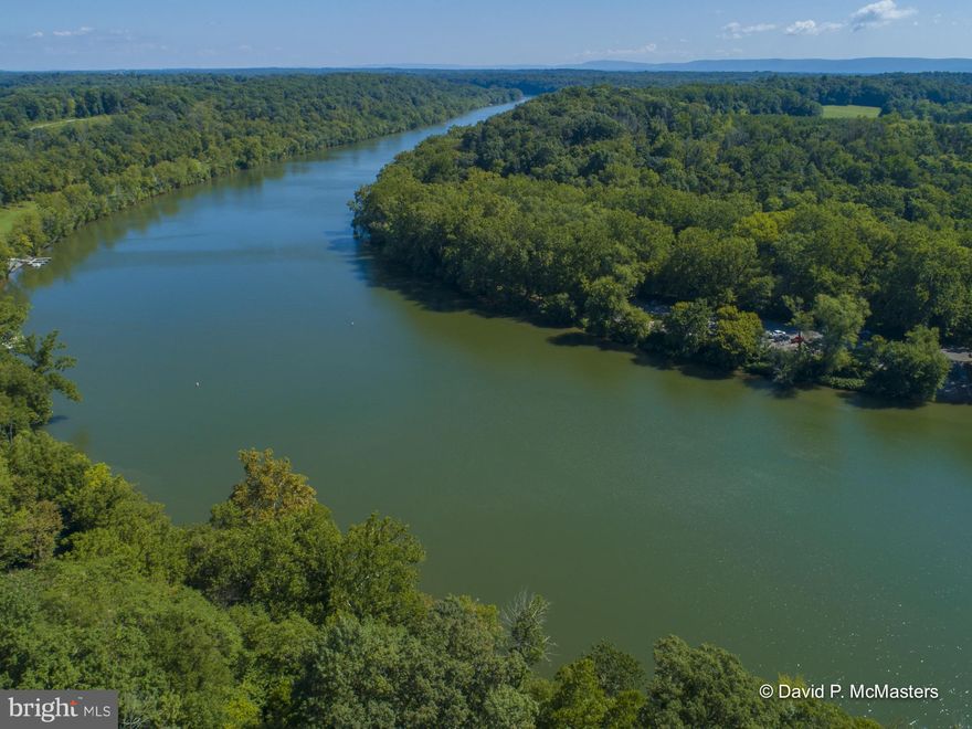 Exceptional opportunity for privacy, natural beauty and  368 Feet of Potomac  deep water Waterfront .  This contemporary home on the end of a winding drive  is elevated above the  Potomac with river views in both directions.  The property contains direct frontage on the Potomac River with commanding views in both directions.   Sited on 2.8 Acres surrounded by mature trees and adjacent on two sides to the Yankauer Nature   140 Acre Preserve, Managed by the  Potomac Valley Audobon  Society.  Great for Spring Wild Flower walks, and walking trails.     Property is served by HIGH SPEED INTERNET -- work from home and enjoy.  Convenient location 8 miles from Shepherdstown ( University town) and near Martinsburg, MARC commuter Train to DC, near I-81. Part of a small community of homes (9), located on a no thru street.  The property contains deeded access to a community riverfront area with a boat launch and large community area. The property lends itself to putting in steps to the river front and installing  your own dock.   Well maintained three level  attractive home with three bedrooms, 2 fireplaces, large family rooms, extensive decking and patios provide a comfortable  setting away from it all.  Views from most rooms. Move easily through multiple sliding doors outdoors and in to the decks and patios.  Large kitchen with upgraded counters, lots of cabinetry.  Detached 2 car garage with large storage space above.  Additional  two carports  ( maybe one for your boat) attached to the house.  Rare find