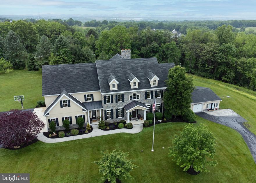 Gorgeous  custom Yingst home nestled in the rolling hills of Edison Woods with a 4 car garage and guest suite. A lovely stoned inviting front porch with an oversized custom door opening into the vaulted foyer with wainscoting, beautiful hardwood floors through out both levels and coffered ceilings in den and office. Dreamy custom kitchen featuring tile backsplash, viking appliances and a large granite island to gather around with family and friends...leading outside to a beautiful stoned patio, pergola and cozy fireplace for entertaining. Sophisticated details through out home include lofty 10 ft. ceilings, custom molding, built in benches, custom lighting, book shelves, 2 stairways, large mud room and 4 fireplaces. Guest large suite (including 1 1/2 bathrooms, living room, kitchen, bedroom, laundry room and sun room)could be used for in laws/older child/college option due to its own separate entry with private driveway and garage.  Enjoy walking down the road to the local farmer for fresh eggs or bike rides in the rolling hills. Must tour in person to see the detailed beauty of this spectacular home and amazing sunsets. Hershey Medical Center only 10-15 minutes from this stunning home.