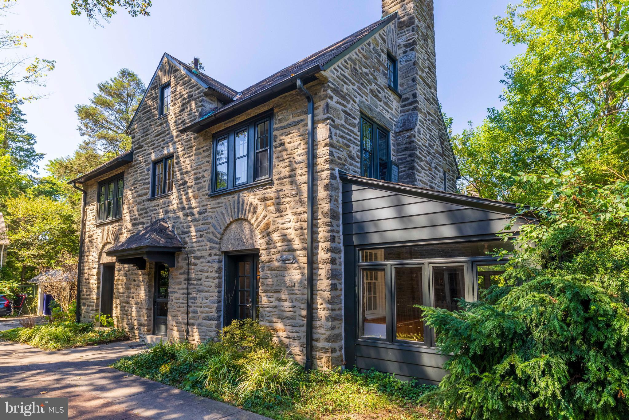 Welcome to 7206 McCallum, a classic all stone Center Hall Colonial, located in a premier Mount Airy neighborhood. within walking distance to Carpenter’s Woods, Weaver’s Way Co-op, and High Point Café. Inside, you’ll find an elegant, wide center hall entry, setting the tone for the home’s gracious layout. The spacious living room features a brick fireplace framed by a wood mantle and French doors leading to a sunroom/family room—an inviting space to read, relax, or entertain, enhanced by walls of windows and handsome built-ins. Opposite the foyer, the formal dining room with its large window, French doors, and elegant lighting, is an inviting space, perfect for gatherings both intimate and festive.
The modern kitchen is thoughtfully designed with rich wood cabinetry, ceramic tile counters, backsplash and floor. A picture windows over the sink, and a built-in desk set by a sunny window making the kitchen a cheerful, bright room and a joyful space to cook and dine in. It also features a double wall oven, gas cook-top, and direct access to the back deck—perfect for indoor-outdoor living.
Upstairs, a sun-filled landing with a picture window leads to the primary suite, complete with two fitted closets, an en suite bath, and a private dressing/sitting room with large fitted closets. A second large bedroom, a ceramic tile hall bath. Generous storage closet, and back stairs to the kitchen complete this level. The third floor offers two additional bedrooms, a hall bath with a claw-foot tub, a large hall closet, and attic storage.
Additional highlights include gleaming hardwood floors, large windows with deep window sills, numerous French doors, unique built-ins, and a rear staircase. The property also boasts a long private driveway and a detached oversized 1-car garage.
Enjoy the convenience of public transportation, nearby parks and trails, and the vibrant shops and restaurants of both Mount Airy and Chestnut Hill—all just minutes away.