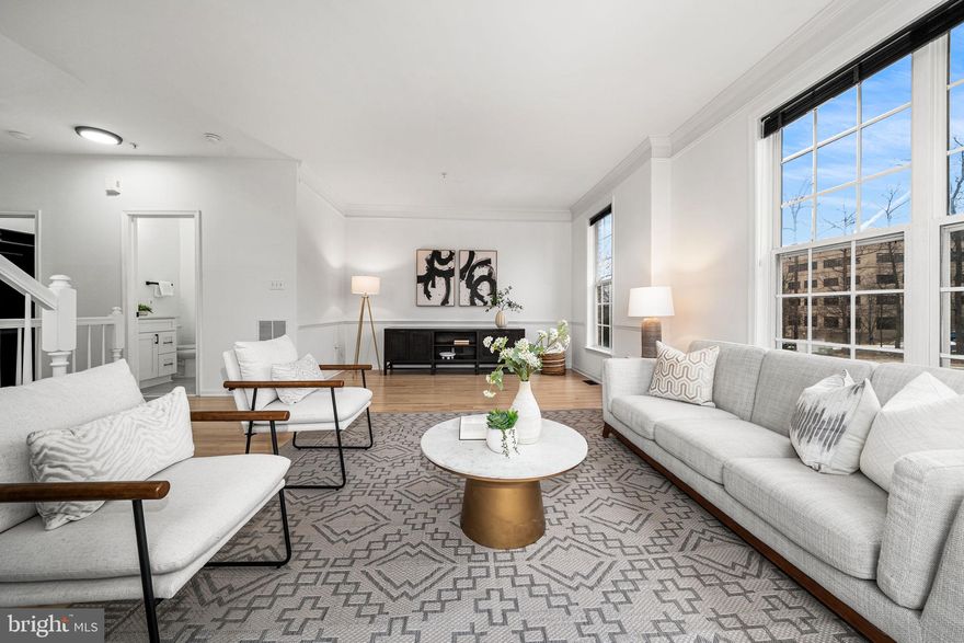 Welcome to The Madison Park Residence, an updated end unit townhome filled with natural light and modern upgrades throughout. The main level opens to a spacious living room that flows into an inviting dining area with custom built-ins and a gas fireplace. The adjoining kitchen has been refreshed with quartz countertops, 42 inch cabinetry, stainless steel appliances, and plenty of storage, creating a comfortable and functional space for everyday cooking. A private terrace extends the main level outdoors, perfect for morning coffee or relaxing in the evenings.

Upstairs, the primary suite offers generous space, refinished hardwood flooring, and a beautifully renovated private bathroom. Two additional bedrooms on this level provide flexible options for guests, work from home needs, or hobbies, and the updated hallway bathroom features modern finishes and thoughtful design.
Recent improvements include fresh paint throughout, new LVP in the entryway, fully renovated bathrooms, refinished hardwood floors, and a newer washer and dryer. The home also includes a one car garage for added convenience.

Residents of Madison Park at West Market enjoy access to community amenities that include a pool, fitness center, clubhouse, sauna, tot lots, and a scenic pond. All of this is a short walk to Reston Town Center with quick access to major commuter routes and the Reston Metro.