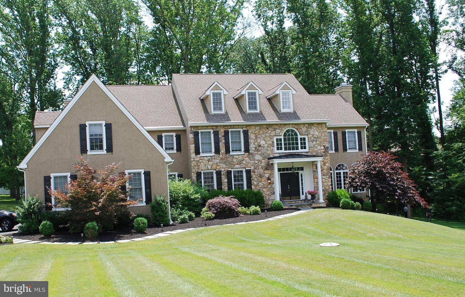 122 Spring Tree Drive is a beautiful, custom built stone manor home located on a cul-de-sac in the enclave of Springton Reserve. The premium 2.15 acre lot adds privacy while maintaining the convenience of living in a neighborhood. Enter the airy 2-story foyer with crystal chandelier, moldings and wainscoting. The entire first floor in adorned with gleaming hardwood floors. To the right is the spacious Living Room with gas fireplace and walls of windows on three sides, bathing the room in natural light. Flow into the formal Dining Room with tray ceiling, wainscoting and medallion. The Gourmet Kitchen is the heart of this home. Beautiful light cabinets with dentil detail and granite countertops, large island, professional Wolf cook top, commercial-grade built-in refrigerator, wine fridge and walk-in pantry. Open to the kitchen is the breakfast room and expansive family room with gas fireplace and vaulted ceiling with palladium window. A slider brings you to a maintenance free deck, perfect for BBQs or enjoying your morning coffee. A study/office, mudroom, two half baths and an attached 3 car garage complete this floor. The second level includes a master suite with his and hers walk in closets with built-in closet system, and luxurious master bath with dual sinks, whirlpool tub and large shower. There are 2 en-suite bedrooms & bathrooms and two bedrooms that share a jack-and-jill bathroom.The walk-out lower level is entertaining heaven with a large open space for various recreational activities: ping pong, video games or hanging with friends.(plumbed for a wet bar) There is a separate media room to watch your favorite movie or sporting event. Great Marple Newtown Schools and close to many private schools, like Episc Academy. Conveniently located near the shops and restaurants of Newtown square and Whole Foods, as well as a short drive to Media, with it s myriad of parades, festivals and Dining Under the Stars. Close to major arteries to access the airport, Philadelphia and Wilmington.