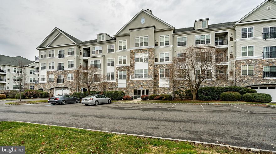 Looking for a Carefree Lifestyle then your search is over in this impeccable one-floor condo in the desirable community The Hollow at Fox Valley.  There is nothing like home and this one offers many upgrades throughout.  Upon entering the unit your eyes are drawn to the beautiful cherry laminate flooring throughout, the freshly painted walls throughout, the 8” baseboard trim, crown molding, extra indirect lighting and wall of windows, a French door that leads to the balcony area overlooking the Gazebo,  quiet community space, and clubhouse all located within the Great room. The kitchen area offers stainless steel appliances, pendant lighting over the eating bar area, upgraded tile backsplash, Corian countertops, gas range, microwave oven, dishwasher and there is seating at the bar area.    The main bedroom displays a chandelier, oversized walk-in closet, and en suite bathroom with upgraded tile floors. The second bedroom has an oversized closet and two good size windows making this a bright and cheery room.  Right off the second bedroom is the hall bath with upgraded vanity, mirror, and tile floor. The large laundry room is located right off the kitchen area with shelving.  To make life easier the trash room is just a few steps down the hall and right next to the elevator which will take you down to the lobby area offers a security system to give you peace of mind and access to the private enclosed heated parking garage (garage doors openers provided and assigned parking spot) so the weather is not a problem when unloading your car to take your items up to your unit. There is a lot of guest parking right outside the building  There is an extra storage locker in the garage area to hold those items you might use just some time and yet need easy access to them. The unit is in close proximity to transportation (bus and train into the city), great shopping centers, Gyms, doctor’s offices, Riddle Memorial Hospital, and you are in between two quaint towns offering restaurants and events. Be the first to view this lovely unit and make yours.