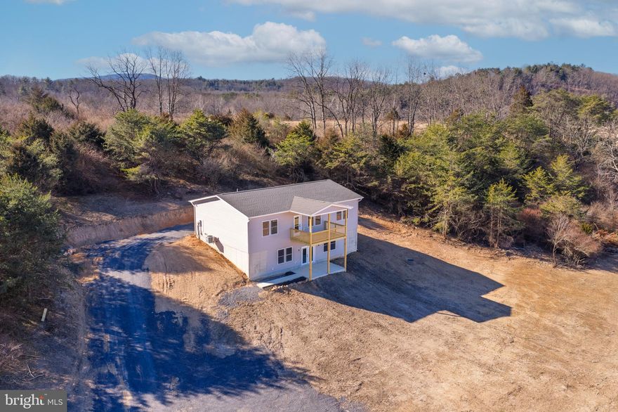 New Construction – 3BR/2BA on 6.2 Acres | 1,536 Sq. Ft. | Completion Dec. 2025
 ***PRICE IMPROVEMENT*** Professional Photos Coming Soon
Experience modern country living in this beautifully designed 3-bedroom, 2-bath home situated on 6.2 private acres with stunning scenic views. Located at the end of a quiet cul-de-sac with no through traffic, this property offers peace, privacy, and convenience just 35 minutes from Winchester, VA.
The open, split-bedroom floor plan features cathedral ceilings in the main living area and 9-foot ceilings throughout the rest of the home. The kitchen includes 42" slow-close cabinetry, granite countertops, a large island, and stainless steel appliances, flowing seamlessly into the spacious living and dining areas. Durable LVP flooring runs throughout.
The primary suite is privately located and offers comfort and style, while the full unfinished walkout basement—with roughed-in plumbing—provides excellent potential for future living space or a recreation area. Main-level laundry adds everyday convenience.