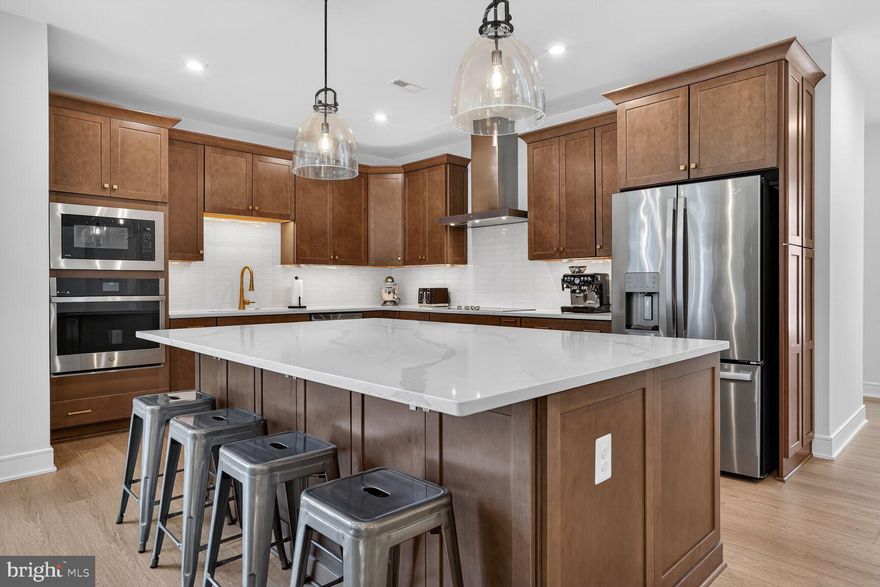 Skip the wait for new construction! This pristine, 1-year-old residence in the sought-after Heritage at Marshall community offers nearly 4,500 sq. ft. of meticulously designed living space across three finished levels. Featuring 5 bedrooms and 4.5 baths—including two primary suites and a recently finished basement—this home is perfectly tailored for both everyday living and grand entertaining. The main level is defined by a light-filled two-story entry, stunning LVP floors, and an open floor plan. A spacious kitchen with stainless steel appliances, a large island, and ample cabinetry flows seamlessly into the living room. This level is complemented by a convenient main-level primary suite, a half bathroom, a spacious mudroom, and an oversized two-car garage with upgraded epoxy floors and custom storage cabinets & racks. The upper level offers three generous bedrooms, including a second primary retreat, a dedicated laundry room, and two additional bedrooms joined by a Jack-and-Jill bath. The lower level is a true standout, featuring a newly finished recreation room, the fifth bedroom, a full bath with an oversized spa-like waterfall shower, and ample storage. Combining nearly new construction with thoughtful post-construction improvements, this exceptional home offers all the benefits of a new build without the hassle of finishing work after move-in. Ideally situated in Downtown Marshall with easy access to commuting routes, local attractions, shopping, and dining, Heritage at Marshall grants residents access to a host of amenities. Enjoy open green spaces with walking and jogging trails, a picturesque outdoor swimming pool, ponds, nature areas, a community clubhouse, and a playground. The HOA includes common area maintenance, lawn care, road maintenance, trash and snow removal, and full access to all community amenities.