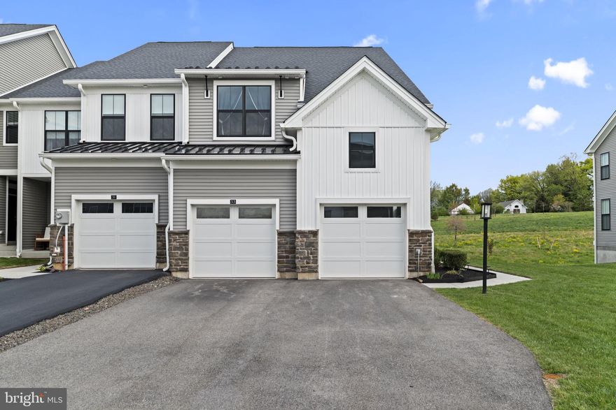 Welcome to 33 Tamarack Circle, a beautifully designed end unit townhome offering 3 bedrooms, 2 full bathrooms, and 2 half bathrooms in a premium private setting.

From the moment you arrive, you will notice the curb appeal, extra side yard, and the rare 2 car garage with plenty of driveway parking. Inside, the home opens up to a bright and airy layout with wide plank flooring and a stunning two story living room centered around a gas fireplace.

The gourmet kitchen is a true focal point, featuring an oversized island, granite countertops, stainless steel appliances, built in oven and range, and an abundance of cabinet space. The open flow into the living and dining areas makes this home perfect for both everyday living and entertaining.

The first floor also offers a private office with double doors, ideal for working from home or creating a quiet flex space.

Upstairs, the primary suite is a true retreat with a vaulted ceiling, large windows bringing in natural light, and an updated walk in closet. Additional bedrooms are well sized and supported by a full hall bathroom.

The finished walkout basement adds incredible versatility with a half bathroom, extra storage, and direct access to the backyard, making it perfect for a second living area, gym, or entertainment space.

Step outside to your private deck overlooking open space with no homes behind you, creating a peaceful and hard to find setting.

This home offers the perfect combination of space, upgrades, and privacy all in one of the most desirable locations. Schedule your showing today.