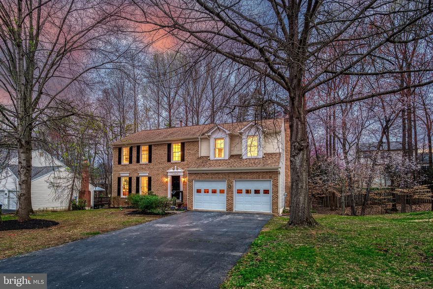 Welcome to this stunning, fully renovated colonial where timeless character meets modern sophistication. Thoughtfully designed for both everyday living and entertaining, the home features elegant formal living and dining rooms, ideal for hosting gatherings. The open-concept layout connects the brand-new gourmet kitchen to a sunlit breakfast area and a cozy family room with a classic wood-burning fireplace. Step outside onto the deck and take in the serene, wooded views—your own private retreat.  At the heart of the home, the new kitchen impresses with 42" soft-close cabinetry finished in a rich tone and accented with champagne gold hardware, luxurious quartzite countertops, and top-of-the-line stainless steel appliances. Sleek recessed lighting and chic modern fixtures add a polished touch. The main level is completed by light-toned wide plank flooring and freshly painted interiors, creating a bright and welcoming atmosphere throughout.  Upstairs, retreat to the impressive primary suite with a soaring ceiling and rich hardwood floors, creating a serene sanctuary. Four additional bedrooms offer comfort and style with brand-new plush carpeting, while the impeccably renovated hall bathroom is a showcase of tasteful design. The fully finished walk-out basement provides expansive living or entertaining space, perfect for every lifestyle. With a roof replaced in 2017 and plenty of life remaining, this home offers not only beauty but peace of mind.  Located in a quiet, sought-after neighborhood, you’ll enjoy tranquility without sacrificing convenience—just minutes from shops, restaurants, and major commuter routes. The community also offers a wealth of amenities including a pool, exercise paths, tot lot/playground, basketball and tennis courts, and even a library. This home truly has it all—style, comfort, and an unbeatable location.