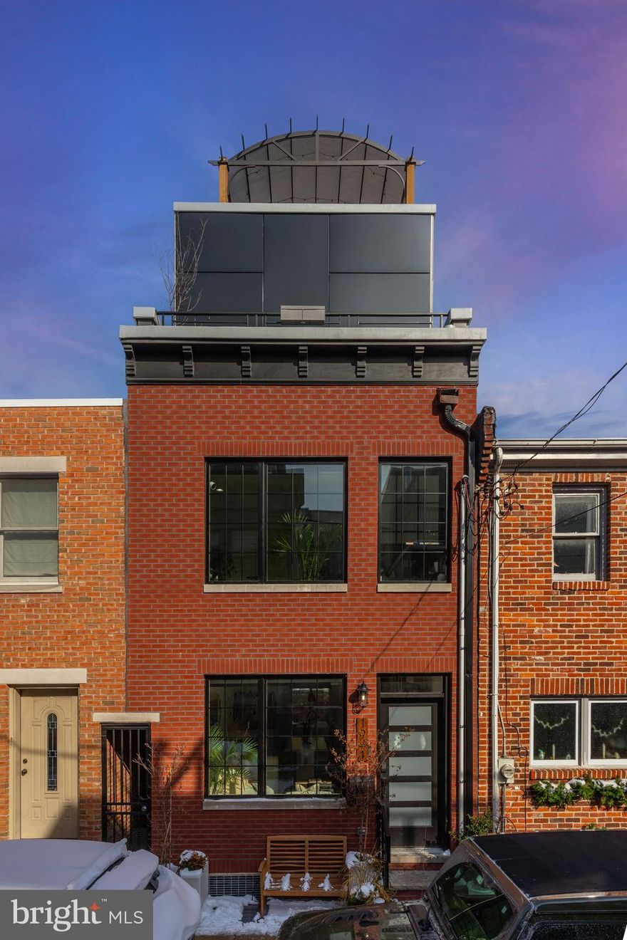 Welcome to 1941 Kater Street! This completely renovated, custom built home, is approached by a tree-lined charming street in the heart of Graduate Hospital, Greenfield Catchment, close to South Street, parks, shopping, dining, and much more! This home has a gracious open floor plan encompassing 2,050 square feet of living space with 3 bedrooms and 2.5 baths. The stylish brick exterior boasts a modern entrance. The interior welcomes you with stunning wide plank White Oak hardwood flooring, an open iron staircase, direct views of the entire first floor, and natural light flowing throughout. The main living area inside features an open living space with electric fireplace, dining area, and to the rear of the home you will find the modern chefs kitchen; complete with white quartz countertops, UltraCraft cabinetry, GE Cafe Series stainless steel appliances with a 6 burner gas stove, subway tile backsplash, exposed brick accent wall, reclaimed wood accents, center island with barstool seating and a wine wall for a decorative type of wine storage. Off of the kitchen is the private outdoor patio, perfect for dining, entertaining, or relaxing during the warmer months. Make your way to the second floor where you will find 2 sizable bedrooms with tons of natural light with custom closets in each, a laundry room, and one full hall bathroom that features geometric tiling, floating vanity, and modern finishes. Moving up to the third floor you will find the private primary bedroom suite complete with custom built-in closets, stunning custom accent wall, and tons of natural light. The luxurious primary bathroom features a custom double floating vanity with quartz counters, walk-in shower with double rainfall showerheads, body wands, and Center City Skyline Views. In addition, the third floor has another custom closet and access to the private roof deck. The private roof deck offers spectacular center city skyline views and features a large Gazebo with covering for bad weather. Move down to the fully finished basement, where you will find a half bath and storage, which adds even more living space. To complete this home, there is a brand new alarm system including a smart doorbell and thermostat. All custom California closets come with a lifetime warranty and there is a brand new sump pump. 1941 Kater comes with  8 Years left on the Tax Abatement from the City of Philadelphia. Schedule your showing now, there is no home like this on the market!