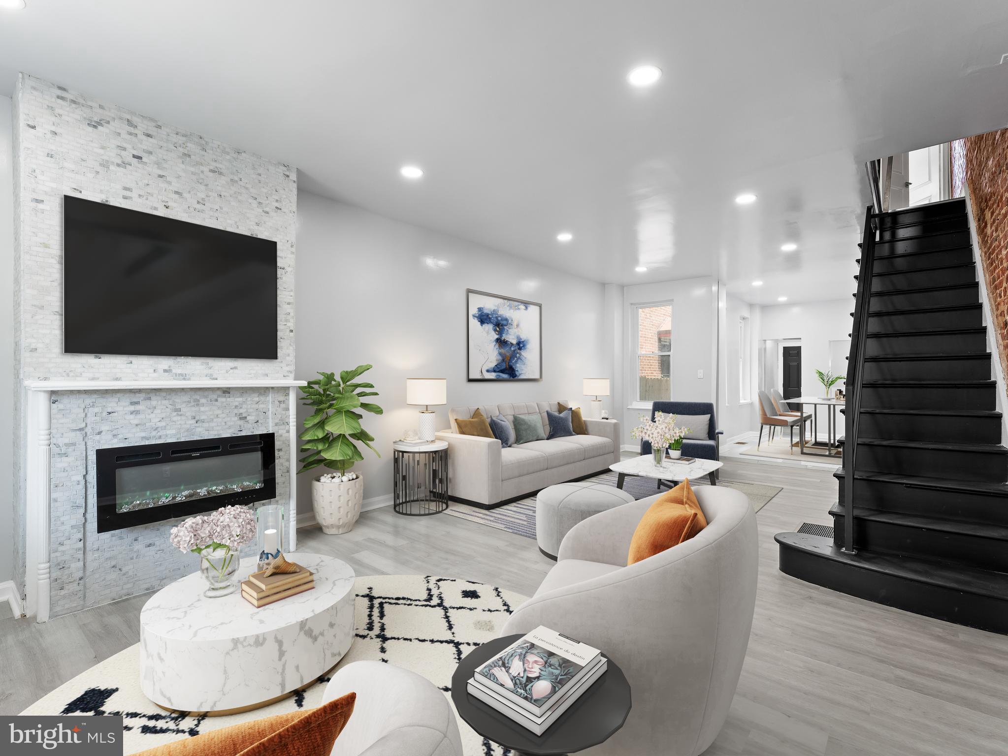 PRICE REFRESH! Welcome to your new home in West Philadelphia! This beautifully renovated 3-bedroom, 1.5-bathroom residence offers a perfect blend of modern luxury and classic charm. Step inside to discover stunning open-concept living space that seamlessly connects to the dining room and kitchen area. The living room boasts an eye-catching exposed brick wall, a built-in fireplace, and recessed lighting throughout, creating a warm and inviting atmosphere. You'll also love the brand-new custom bannisters that add a touch of elegance throughout the home. The fully finished basement provides additional living space, perfect for a home office, gym, or entertainment room. Convenience is key with a washer and dryer included in the unit. Central AC ensures comfort throughout the year. Outside, enjoy the newly landscaped back patio—ideal for relaxing or hosting gatherings. Located right across the street from the green space of Cobbs Creek Park, you'll have endless opportunities for outdoor activities and recreation. Don't miss the chance to make this stunning West Philadelphia home yours!