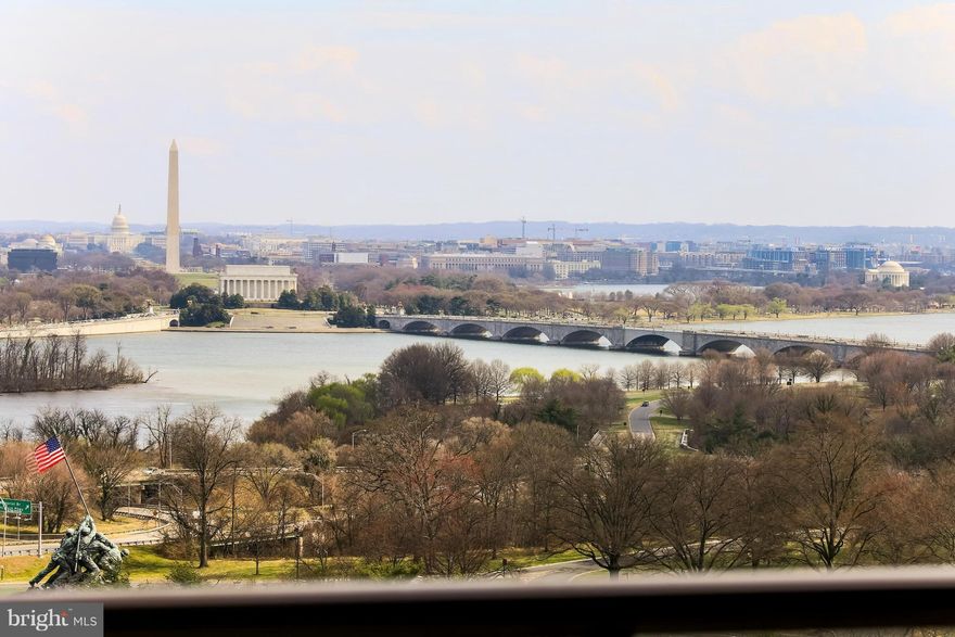 Rarely available multi-level unit with the "finest" unobstructed views of Washington, DC, the monuments, and the Potomac River. This home, in the exclusive Weslie Condominium in Rosslyn, features:  a concierge, garage parking, manicured grounds and more. Enter the unit's foyer and go up the gently curved stair to your large / magnificent living room with soaring 13 foot ceilings, built-ins,  and a wall of windows with motorized drapes. The living room leads to a generous balcony overlooking the city and monuments with plenty of outdoor space for dining and relaxing. The large kitchen contains custom cabinetry, abundant counter space and more city views.... All three bathrooms have been completely remodeled, including a Jacuzzi tub, dual sinks in the primary bathroom , plenty of storage, and heated towel racks. Enjoy a separate dining room overlooking the living room and Washington, DC, lots of closet space, beautiful NEW wood flooring, and indoor parking 'plus' a separate storage unit on the garage level. The home also has abundant custom lighting and Surround Sound throughout... control the sound, lights, drapes from home or away. Located on the hill behind Iwo Jima, the Weslie condominium not only offers the most breathtaking views and easy commuter access to DC, but also provides easy visitor parking in the front and a "state of the art" gym facility. Entertain inside and out in this gracious home, with Georgetown, Rosslyn Metro, parks, bike/jogging trails, DC and Reagan National Airport all close at hand.