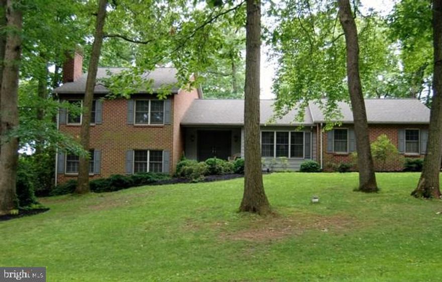 So much room in a well maintained home on .85 acre wooded lot. Gourmet kitchen, granite, tile, huge pantry, opens to 27x16 deck; Owners Suite, 4 piece bath has new tile; Lowest level FR with FP & wet bar, full bath; work from home in quiet den opening to stamped concrete patio. And the landscaped yard is a haven!  LL possible sep living. Newer roof, furnace, A/C