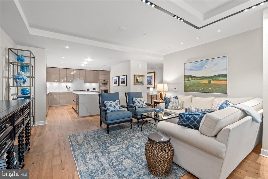 Welcome to luxury living at its absolute finest at the Pierce in Rosslyn. Unit 202 is a two-bedroom, 2 full bath, 1769 sq ft home that epitomizes luxury. Walk into the inviting entry hall and notice the hand scraped hickory floors, tray ceilings and museum quality lighting throughout. The gourmet kitchen has been designed for the discerning chef and features Snaidero cabinetry, Thermador appliances and quartz countertops. The island with its seating for 4 and waterfall countertops will make cooking and entertaining a true delight. The kitchen also features a dual zoned wine fridge, gas cook top and a walk-in pantry. The expansive living and dining area is ideal for entertaining whether it’s an intimate dinner party or a large gathering. The sweeping floor to ceiling windows frame the soon to be blooming gorgeous trees and let in ample natural light. The private spacious balcony allows for a tranquil space to unwind and enjoy the greenery and vibrancy of the city in a serene environment. On the other side of the home, tucked away from the living areas for ultimate privacy, you will find the two bedrooms. The owner’s suite is a true place to escape and relax. The suite features a custom designed walk-in closet for plenty of storage, a lovely tray ceiling, floor to ceiling windows, black out shades for a restful night and a spa inspired ensuite bath. The bath features a walk in glass shower, dual sinks, ample storage, heated marble floors, marble countertops and a separate water closet. The 2nd bedroom offers guests their own private retreat and features a custom walk-in closet, black out shades and has plenty of space for a home office. A 2nd full bath features a soaking tub/shower, marble floors and marble countertops. A separate laundry room with a full-sized washer and dryer and a utility sink just adds to the convenience and ease of living in this home. Unit 202 comes with a storage unit located just steps across the hall. But the luxury does not end there. The Pierce offers a luxurious lifestyle with top-tier amenities. Just down the hall, from unit 202, residents can enjoy a cutting-edge two-story fitness center, complete with a full range of machines, weights, and a yoga room. For relaxation, there’s a resort-style 65-foot rooftop pool with an outdoor bar, lounge, and grilling area, as well as a sophisticated club room featuring a fireplace and bar. The rooftop terrace offers a gourmet cooking area, chic lounge spaces, and stunning panoramic views of Arlington and DC. Additional amenities include, a conference room, on-site bike storage, electric vehicle charging stations, a dog-washing station, and two reserved garage spaces. A 24-hour concierge service ensures that every need is met with exceptional attention. Positioned in the heart of Rosslyn, this residence is close to restaurants, grocery stores and shopping. The Pierce is also pet friendly. Nature enthusiasts will appreciate nearby Freedom Park, Gateway Park, Roosevelt Island, and the Mount Vernon Trail along the Potomac. Located just a 10-minute drive to Reagan National Airport, travel and weekend getaways are made easy. The Pierce is just a quick stroll to the Rosslyn Metro. Georgetown is just a short walk across the Key Bridge. Let this home and the Pierce become your ultimate luxury residence.