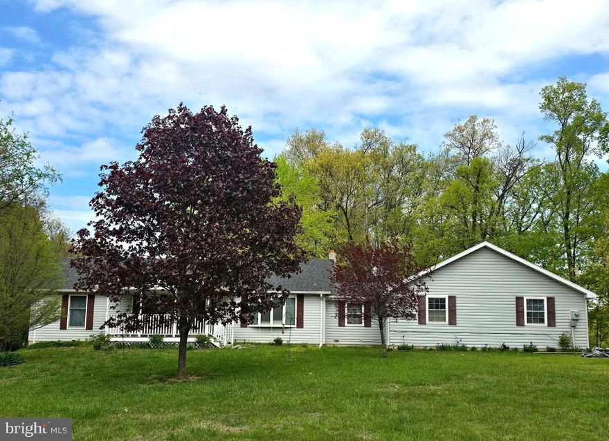 Cozy Foremost Rancher with full, unfinished walk-out basement, situated on 2.44 acres, with an additional .52 acre parcel included for a total of just under 3 acres (2.96).  The home features 3 bedrooms and 2 full bathrooms - one with a shower, and the other with a tub/shower combination.  The primary bedroom offers a spacious sitting room with closet.  The main living space provides ample lighting through the large bay window, and just off the side of the living room is a formal dining space.  The country style kitchen offers convenient counter space with a center island, as well as a breakfast bar.  Next to the kitchen is a roomy laundry/mud room with vaulted ceilings, as you enter the home from the substantial 2 car attached garage.  The property also features a large garage/barn with separate 100 amp service installed.  The highlight of this property is the peace and quiet you will find in the expansive yard and back deck.  Located less than 3 miles from downtown Berkeley Springs, Town of Bath with all of its local shops and restaurants, this property has everything you need and more!