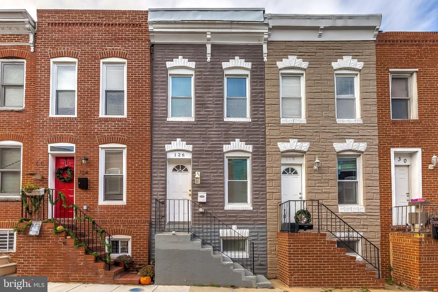 LIKE NEW!  This fully renovated property is steps to everything canton and fells point has to offer & walking distance to Hopkins!   3 finished levels with an open floor plan on main level with beautiful hardwood floors, 1/2 bath,  wainscoting and crown molding throughout the house. High end finishes in the kitchen including granite counters, tiled backsplash and SS appliances.  The upper level includes 2 large bedrooms and a huge full bathroom with separate soaking tub and frameless glass shower.  Basement offers 10ft ceilings with a 3rd bedroom in the basement along with another full bathroom and full sized laundry area.  Fresh paint throughout! Enclosed fenced back patio perfect for entertaining.  Security Door installed in 2020.  Schedule a showing today!