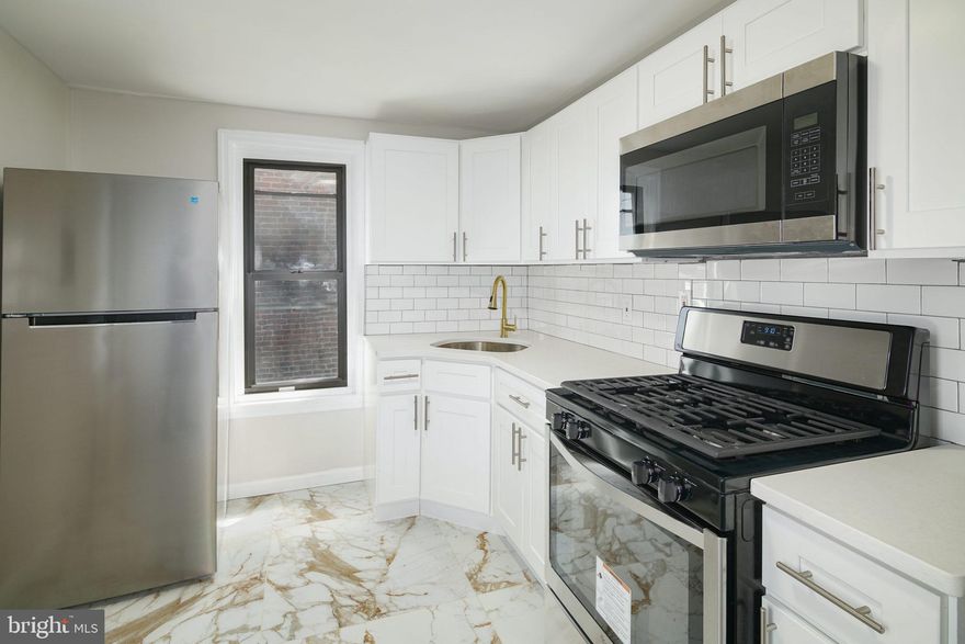 Welcome to this stunning, fully renovated unit located in the heart of POINT BREEZE! This one-bedroom, one-bathroom unit has been beautifully updated with hardwood floors, elegant large marble tiles, recessed lighting, and Ductless Mini-Split Wall Units for efficient cooling. The spacious eat-in kitchen boasts ample cabinet space, stainless steel appliances, including a built-in microwave, and upgraded countertops. The oversized bedroom offers generous closet space for all your storage needs, complemented by a modern light fixture. The bathroom is a work of art, featuring textured marble-style tiles, a contemporary white vanity with storage, and a mirrored vanity above the sink for your toiletries. The large tub shower is equipped with modern tiles and fixtures. Located in the sought-after Point Breeze neighborhood, this unit is a walker's paradise with a Walk Score of 94. All your daily necessities are just a short stroll away, including groceries, schools, dining options, cafes, bars, and shopping. Nearby parks like Girard Park, Smith Playground, and Wilson Park offer outdoor recreational opportunities. Don't wait too long; this unit is sure to be in high demand. Schedule your showing today before it's gone!