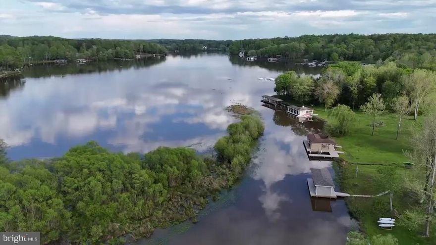 LAKE LIFE AWAITS.  WATERFRONT - LAKE ANNA - PUBLIC SIDE-  BOAT HOUSE- High speed internet available -  Fantastic price, complete with a  2 story boathouse! This brand-new, move-in ready Loreto model combines modern comfort, thoughtful design, and true waterfront living. With over 3,900 square feet under roof, this home features vaulted ceilings, an open-concept design, and abundant natural light. The main level offers a spacious primary suite with an oversized walk-in closet, a luxurious bath with freestanding tub and tile shower, and two more bedrooms with ample closet space (1 bedroom NTC- septic). The gourmet kitchen is a chef’s dream, complete with stainless steel appliances, a large island, and high-end finishes, perfect for entertaining. Enjoy beautiful sunsets from the composite deck overlooking more than 160 feet of waterfront. The walk-out lower level includes a recreation room, full bath, and an additional guest suite. A rare double-decker boathouse conveys, complete with a boat lift, two jet ski lifts, a screened-in porch, an upper deck for lounging and sunning, and a storage closet for all your lake gear. Located in the charming Frazer’s Landing community on Lake Anna’s public side, this home offers easy access to wineries, breweries, Lake Anna State Park, restaurants, shops, and more.  The HOA DOES allow for short term rentals, so if you are dreaming of being an Air BNB owner, look no further; this is the home for you.  Don’t miss this opportunity to own a brand-new waterfront home with a fantastic double-decker dock—move in and start living the Lake Anna lifestyle today!