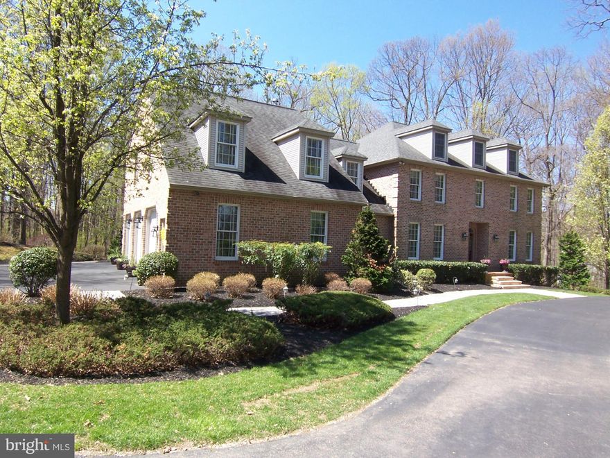 CUSTOM, QUALITY CONSTRUCTION AT GREAT PRICE! (Price just reduced $25,000) ALL BRICK home on private & sunny oasis encircled by woods in FALLS CREST community. Recent custom built gourmet kitchen & Gourmet full bar in LL. Beautiful hardwood floors. Private office. New carpet in all bedrooms. Tons of storage on every floor! MUST SEE to appreciate this incredible value!