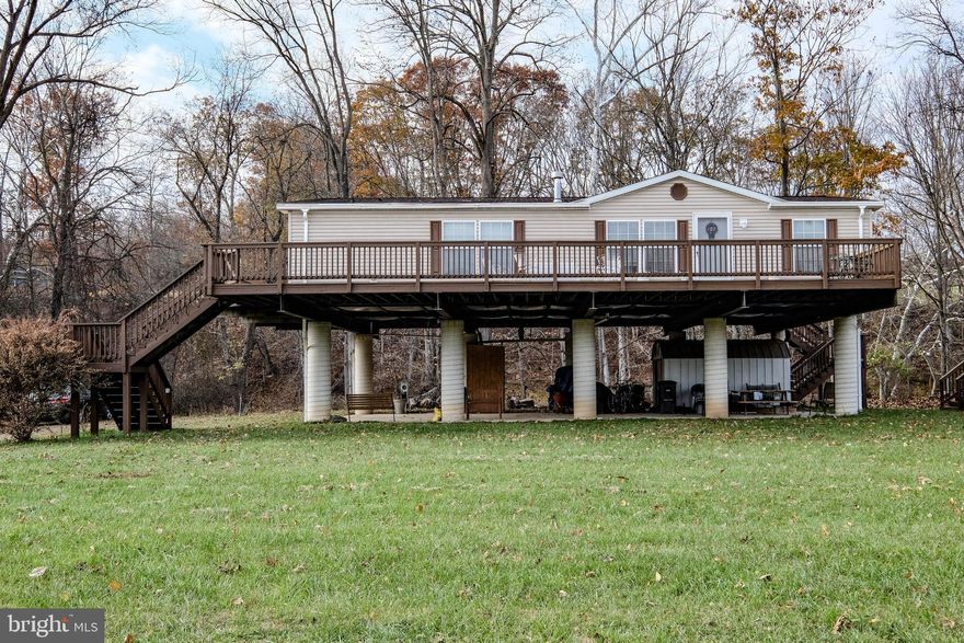 River Living In Capon Bridge WV-Hampshire County WV! You Will Be Wowed By This Beautifully Kept Home On .872 Acres Next Right On The Cacapon River!  Come To Wild Wonderful West Virginia And Wake Up To The Sounds Of The River, Deer,  Birds, Rustling Leaves.  Peaceful Living Just 20 Minutes From Winchester, Walmart, Medical Center, Shopping, Commuter Routes! This Home Boasts 3 Bedrooms, 2 Full Baths With Open Kitchen, Tons Of Storage, Counterspace, Skylights, View Of The River From The Kitchen And View Of The Mountains From The Front Living Area. The Kitchen/Dining Room/Living Room Combo Is Warm And Functional With A Beautiful Stone Fireplace, With Decorative Wood Beams! The Primary Bedroom Is Spacious , With Closet Space and A Sitting Area. Primary Bathroom Is Large With Soaking Tub And Skylight!  The Laundry Room Is Just Off Of The Kitchen With A Washing Sink And Storage.  Going To The Exterior Of The Home, There Is A Large Wrap Around Deck With Sunrise Views and Sunset Views!  The Pillars And Steel Beam Architecture Were Designed To Be Its Height On Purpose, And To Withstand Any Amount Of Water That May Incur On The Grounds.  The Pillars Were Designed and Built By Thurman W Whisner, Professional Engineer And All Documents And Elevation Certificate Approved Is With Documents In Listing.  The Playful Area Outside Includes An Above Ground Pool With Deck, Firepit, Dock And Access To The Water!  The Under Area Of House Is Used Currently As A Carport, Storage, Picnic Area!  Use As Permanent Home Or Vacation Home! This Home Has  A Flood Zone Certification And Docs Are Uploaded. This Home Sits On Extremely High Engineered Concrete Pillars (Again All Documents Available) Higher Above The Flood Zone-No Flood Zone Insurance Required.