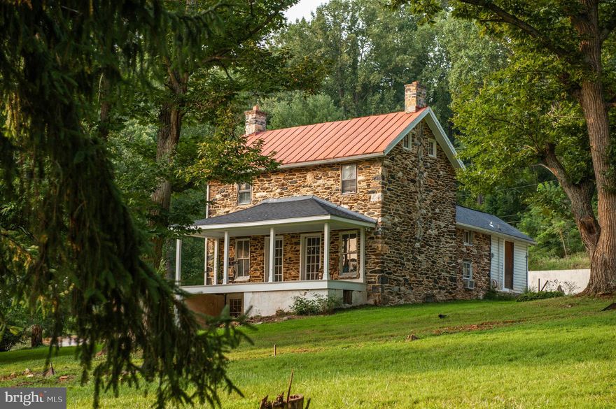 Live authentically. The Caretakers House circa 1852. Prime with potential. This property is a canvas awaiting your vision. Endearing farm stonehouse. See attached plans, with the seller’s vision for expansion or make the current footprint your cherished homestead. A secluded haven nestled on 1.53 acres, where nature and architecture harmoniously coexist.  Surrounded by a lush, mature woodland, this property offers the ultimate private retreat. Charming stone exterior artistically repointed. The sellers have preserved its timeless character. Picture pathways winding through the property, perhaps leading to a secluded garden or a meditation space. Envision an expansion that complements the natural beauty that exists. Design interiors that blend contemporary style with rustic elements. The new well, plumbing, and electric systems ensure that the home is equipped with the latest in modern convenience. Hydronic heating flows beneath the floors, providing efficient warmth throughout. Massive stone fireplace anchors the great room. Venture down to the wine cellar, and you find yourself in a space that evokes an ancient aesthetic. The stone walls create a cool, serene atmosphere that is ideal for preserving your collection. Whether you seek a peaceful retreat, a place to entertain, or a space that inspires creativity, this home embodies infinite inspiration. Incredible proximity to Hunt Valley, Four Corners, NCR Trail, The Reservoir. Hiking and nature abound. 
• Xfinity Internet
• Please see sellers amenity list, additional documents, and plat as available on our website. 
Cultivate your existence. The art of uniting human and home.