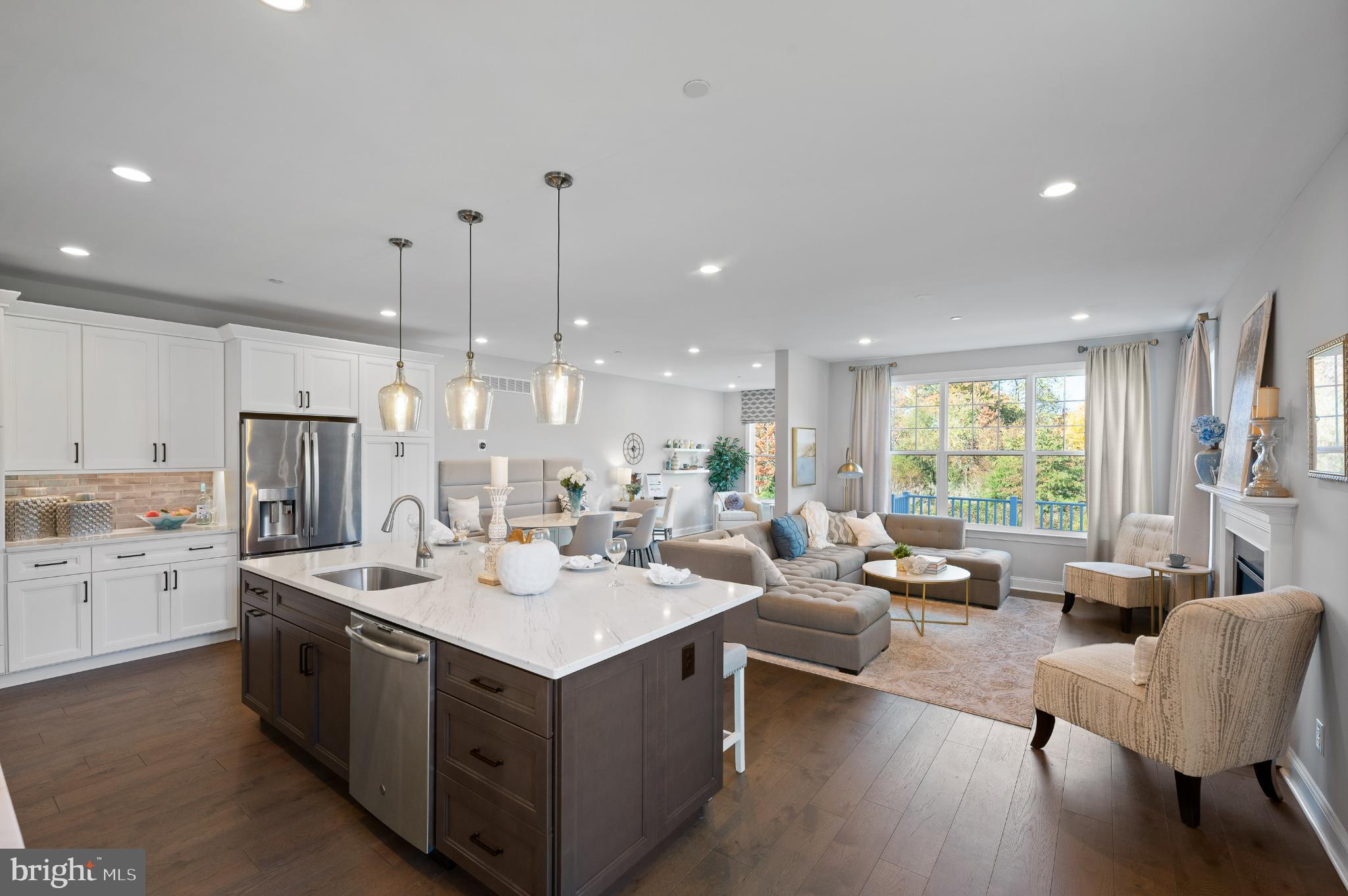 Built by Rouse Chamberlin Homes and located in the highly sought-after Enclave at Ridgewood community, our former Sutton Grand, Furnished Model home is now for Sale. This designer end-of-row townhouse offers a harmonious blend of luxury and comfort. With three spacious bedrooms and three and a half designer-chosen bathrooms, this residence is designed for both relaxation and entertaining. Step inside to discover an open floor plan that seamlessly connects the living, dining, and gourmet kitchen areas. The heart of the home features a redesigned New Kitchen with upgraded countertops, an enlarged island perfect for casual dining, and a pantry that caters to all your culinary needs. Stainless steel appliances, including a built-in microwave, wall oven, and gas five-burner cooktop, elevate your cooking experience. The inviting Great Room, adorned with a gas fireplace and elegant mantel, creates a cozy atmosphere for gatherings or quiet evenings at home. Natural light floods the space through the many large, double-pane, energy-efficient windows, enhancing the warmth of the engineered hardwood flooring. The primary suite is a true retreat, boasting a Tray-Ceiling, luxurious walk-in closet, and a spa-like bathroom complete with a walk-in shower, ensuring a serene escape at the end of the day. The fully finished walkout basement offers additional living space, perfect for a home theater, gym, or play area, while the upper-floor laundry adds convenience to your daily routine. Thoughtful details such as recessed lighting and a sprinkler system enhance the home's functionality and aesthetic appeal. Outside, the property is beautifully complemented by exterior lighting, sidewalks, and street lights, creating a welcoming ambiance. The deck provides an ideal setting for outdoor entertaining or simply enjoying the tranquil views of the surrounding trees. The corner homesite offers added privacy, making it a peaceful sanctuary. With an attached two-car garage and driveway parking, convenience is at your fingertips. The community amenities, including jogging paths, playground and sidewalks that foster an active and engaging lifestyle. This home is not just a residence; it's a lifestyle choice that embodies luxury, comfort, and community. Experience the perfect blend of modern living and natural beauty in this exceptional property.