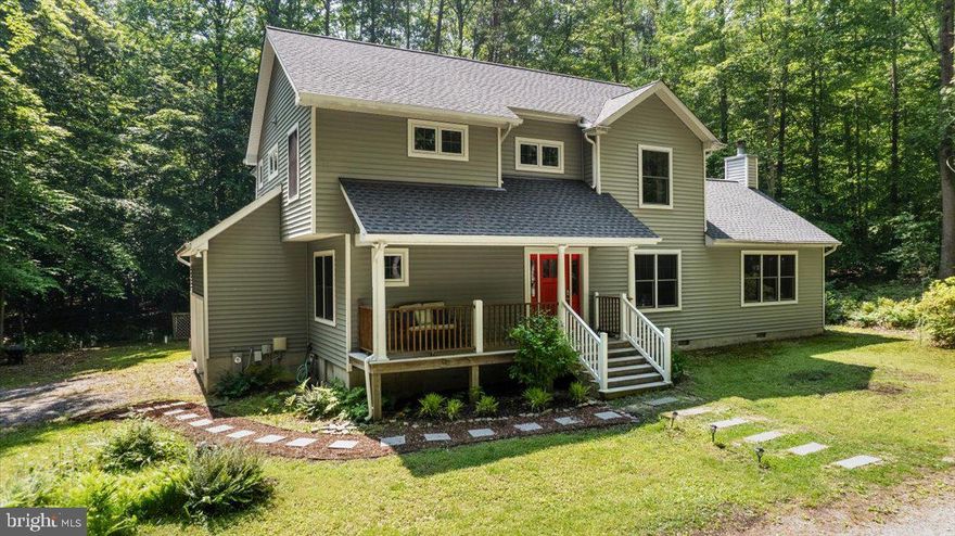 Nestled within and surrounded by privately owned forest woodland, this lovely home on two secluded acres is your retreat. Immerse yourself in the sights and sounds of the woodland birds and wildlife from the comfort of the front porch and private screened porch or take a nature hike through the surrounding forest. Inside a welcoming contemporary floorplan awaits. The heart of the home is the open kitchen with center island which opens to both the dining area and sweeping great room. Luscious wide plank pine  flooring throughout the home. Vaulted ceilings and wood burning fireplace grace the great room with exit onto the screen porch. Forest views await from each of the home’s oversized windows. Main level bedroom/office and full bathroom with shower are set off to the side for privacy. Four spacious bedrooms grace the home’s upper level including the primary suite with private bathroom and balcony. Upper level laundry. Abundant storage and closet space. Carry groceries directly into the spacious pantry and kitchen from the side load garage. HVAC new in 2022, roof new in 2023. No HOA. Freshly painted and ready for you!