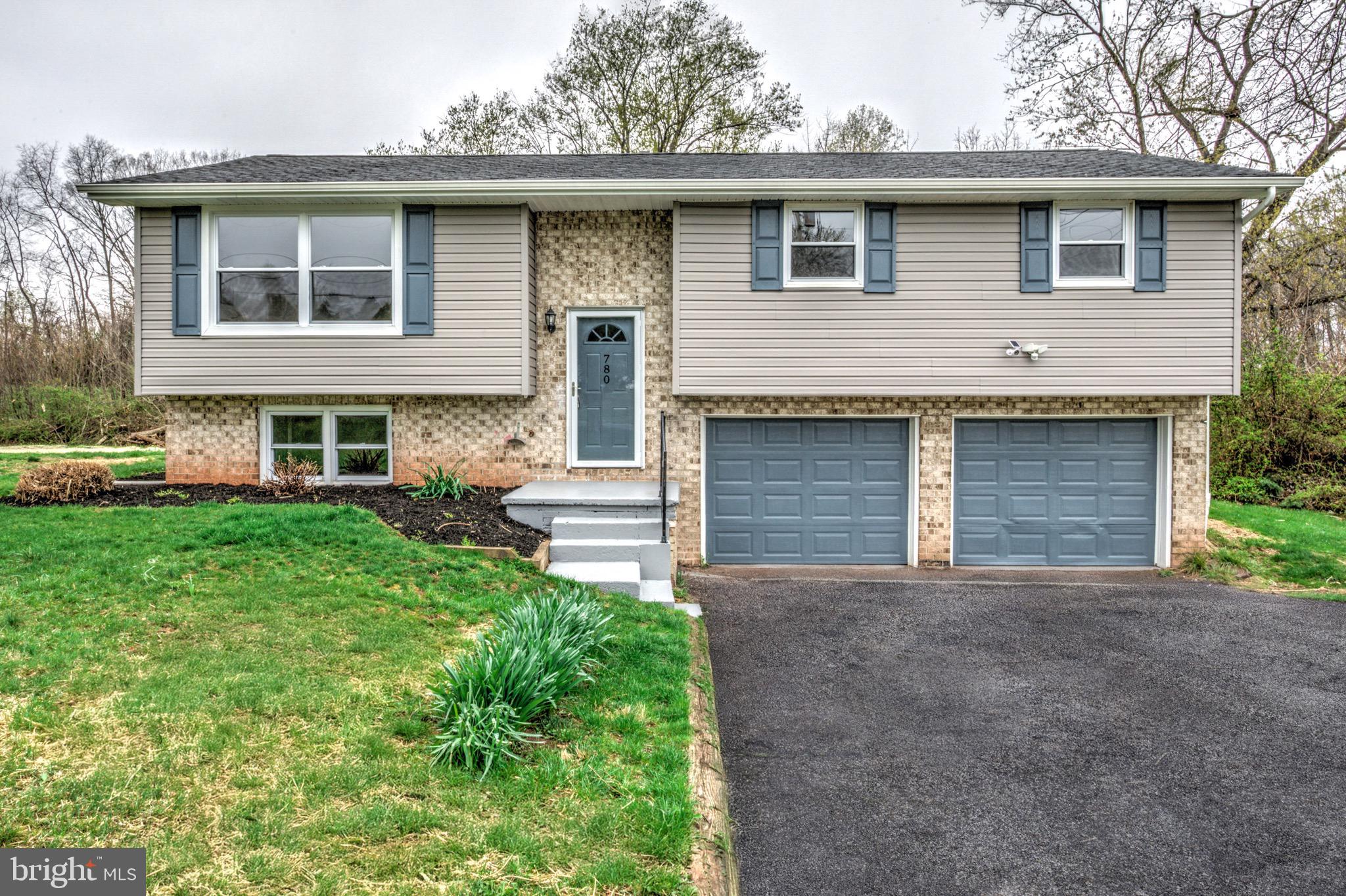 Welcome to a beautifully renovated, bi-level home set in a peaceful area amidst tranquil farmland and Conewago Creek north of Manchester. With 3 bedrooms (as well as a possible 4th bedroom on the lower level!), 2 full bathrooms, and a two-car attached garage, this home offers both comfort and convenience. Inside, you'll find a bright and airy living space with fresh paint and a combination glowing hardwoods and attractive luxury vinyl tile flooring. The large eat-in kitchen features sleek stainless steel appliances, stunning quartz countertops, and a stylish tile backsplash. Step outside through the double glass doors off the dining area to enjoy views of your private yard from the covered rear deck—perfect for relaxing or entertaining. The bedroom wing is home to a desirable primary suite which is a serene retreat with its own private ensuite bath. Two additional, spacious bedrooms share a second full bathroom, ensuring plenty of space. The downstairs bonus living area offers a cozy space with plush carpeting, ideal for a family room, home office, playroom - or possible 4th bedroom! Notable upgrades include a brand new efficient heat pump for year-round comfort and an inspected septic system for added peace of mind as well as a recently sealed driveway. This well-maintained home blends modern upgrades with functionality in a tranquil neighborhood setting—perfect for those seeking a move-in-ready property in Manchester.