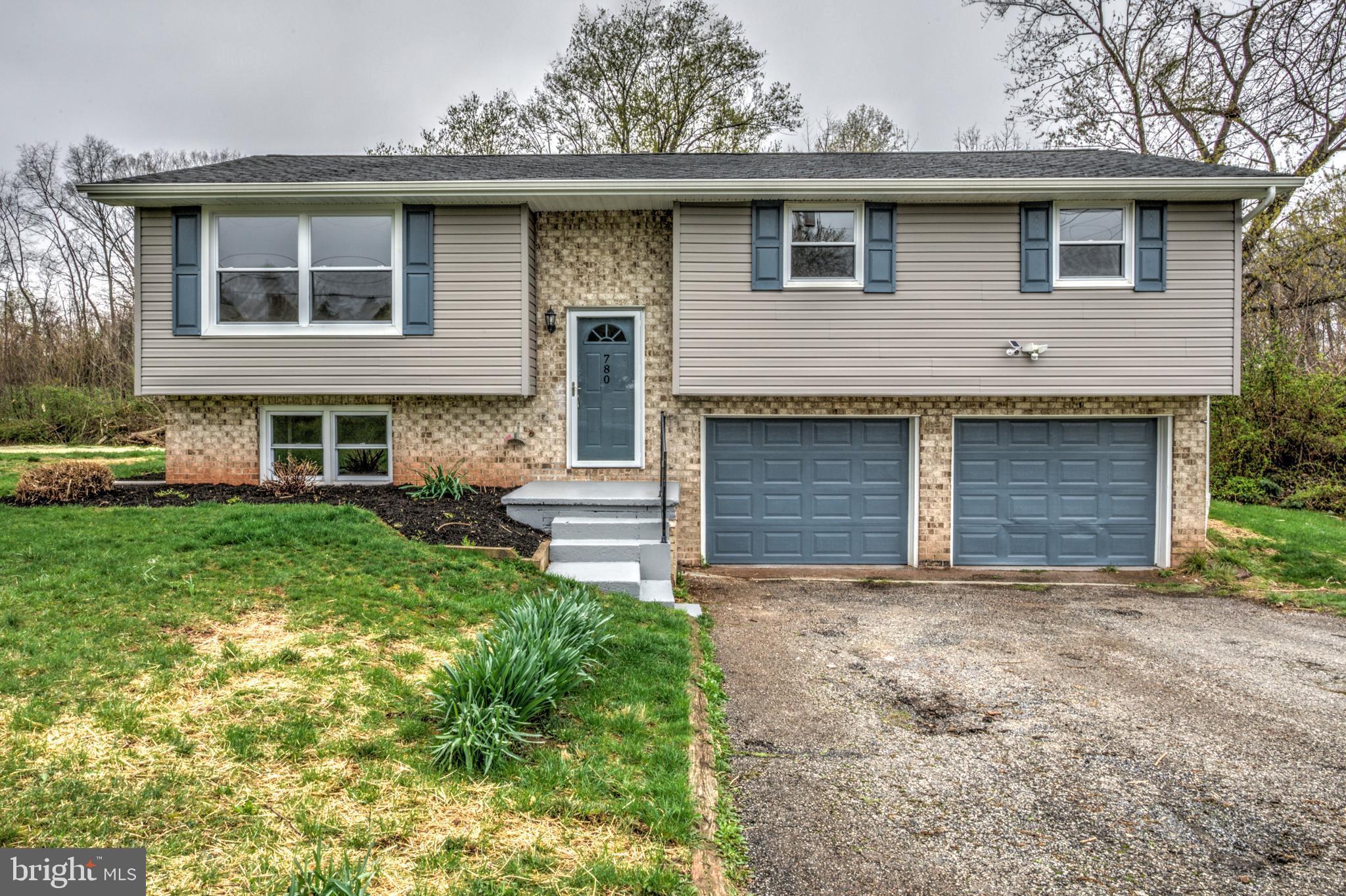 Welcome to a beautifully renovated, bi-level home set in a peaceful area amidst tranquil farmland and Conewago Creek north of Manchester. With 3 bedrooms (as well as a possible 4th bedroom on the lower level!), 2 full bathrooms, and a two-car attached garage, this home offers both comfort and convenience. Inside, you'll find a bright and airy living space with fresh paint and a combination glowing hardwoods and attractive luxury vinyl tile flooring. The large eat-in kitchen features sleek stainless steel appliances, stunning quartz countertops, and a stylish tile backsplash. Step outside through the double glass doors off the dining area to enjoy views of your private yard from the covered rear deck—perfect for relaxing or entertaining. The bedroom wing is home to a desirable primary suite which is a serene retreat with its own private ensuite bath. Two additional, spacious bedrooms share a second full bathroom, ensuring plenty of space. The downstairs bonus living area offers a cozy space with plush carpeting, ideal for a family room, home office, playroom - or possible 4th bedroom! Notable upgrades include a brand new efficient heat pump for year-round comfort and an inspected septic system for added peace of mind. This well-maintained home blends modern upgrades with functionality in a tranquil neighborhood setting—perfect for those seeking a move-in-ready property in Manchester.