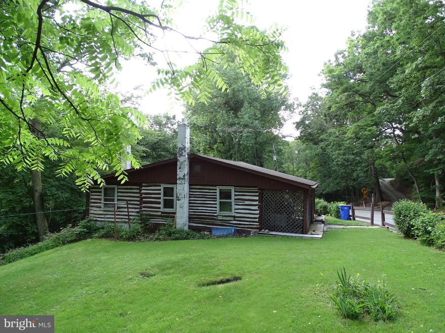 Two Bedroom Log Home on 3+ wooed acres!!!!   On the 1st floor, this property features: Kitchen, Dining Area, Loft / Computer area, Bedroom, and Master bedroom with full bath.  "walk in shower".  In the lower level you will find a Rec Room, Utility / Laundry Room, and a back room that has a door to the back yard and Deck.  The Septic system is on the left side of the home, the well is in behind the stone retaining well by the driveway.  There is a detached shed with a garage door and a walk out basement.   Enjoy nature with the 3+ acre wooded lot.   This home needs work.   Bring your creativity and a hammer.