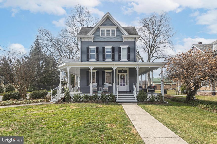 Timeless Victorian Elegance in the Heart of Yardley Borough!  Step into the charm of this beautifully preserved and updated early-1900s Victorian, where classic architecture and modern comforts come together seamlessly. A gracious wrap-around front porch sets the tone, offering the perfect place to relax and enjoy the character of this inviting home.  Renovated with care , the home harmoniously blends historic charm with modern sophistication, showcasing solid oak and pine floors, custom oak doors and pocket doors, an exquisite stained glass window, and an architecturally stunning main staircase. Inside, a welcoming foyer opens to generously proportioned living spaces designed for both everyday living and entertaining. The living room and formal dining room showcase the home’s historic appeal, while the comfortable family room features a cozy gas fireplace—an ideal gathering space on cooler evenings. The gourmet kitchen is thoughtfully appointed with an island, abundant cabinetry, and ample workspace for the home chef. A convenient half bath and a practical mudroom complete the main level. Two elegant staircases provide effortless access to the upper levels.   The second floor hosts a spacious primary bedroom retreat with a walk-in closet, along with two additional bedrooms and a convenient laundry closet. An updated hall bath serves this level and features a luxurious soaking tub and a walk-in shower.  The third floor offers exceptional flexibility with a sizable fourth bedroom or study and its own private bathroom, highlighted by a beautifully tiled walk-in shower with bench seating—perfect for guests, an au pair suite, or a private office.  Outdoors, the partially fenced backyard provides multiple spaces for relaxing and entertaining, including a deck and a patio. Completing the property is a detached two-car carriage house to the rear, offering generous storage and endless possibilities.  Situated just steps from restaurants, boutique shops, the Delaware Canal Path, Yardley Train Station, Yardley Country Club, and Lake Afton, this home offers the ultimate combination of historic character, modern luxury, and unparalleled convenience. With Pennsbury schools and seamless access to Philadelphia, New York, and Princeton, this estate truly epitomizes refined suburban living.  Rich in character and thoughtfully updated for today’s lifestyle, this exceptional Victorian offers the rare opportunity to enjoy historic charm with modern convenience.