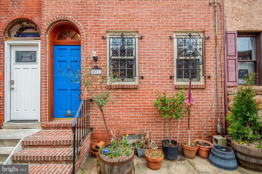 Welcome to 821 South 10th Street, an enchanting home nestled in the heart of the Italian Market in South Philadelphia. This delightful residence offers 3 cozy bedrooms and a well-appointed bathroom. Enter through a foyer to a living room with original random width hardwood floors and be greeted by the seamless integration of ornate ironwork, stained glass, bespoke tiles and exposed brick walls. An updated kitchen with gleaming stainless steel appliances, installed by the current owner, and plenty of cabinets is as functional as it is attractive. Outside, a comfortable back patio is adorned with a captivating custom mosaic mural, a one of a kind art piece commissioned by the owner and unlike anything you’ve ever seen.  On the 2nd level find 2 bedrooms and a bathroom with hand painted sink and custom woodwork. The top floor includes a generous primary bedroom and access to an unfinished attic, perfect for storage or future living space. A basement includes a washer and dryer and plenty of room for storage. Almost every window and interior door has been replaced, and newer air conditioning and newer water heater make for easy, maintenance free living. Conveniently located steps from the bustle and charm of the Italian Market, this home is just a joy to experience. Don't miss the chance to make this remarkable property your own. Reach out today to schedule a showing and discover the allure of this inviting residence.