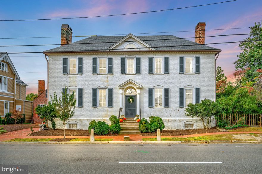 Own a piece of Fredericksburg History.  This Beautiful Federal Style Home was built in 1780 and had additions of the Kitchen, Back Porch, Bedroom and Sunroom in the 1930’s. Even with changes over the years, the Home has maintained its original charm and beauty such as Wide Plank Hardwood Floors, Paneled Walls, Crown Moulding, 4 Fireplaces & Mantels, Built-in Wood Shutters, Hand Painted Wallpaper in the Dining Room, Detailed Archway in Grand Hallway, Fanlight Window above Entrance Door, Rear Shuttered Doors that open to Back Patio and Gardens – just to name a few.  Sunroom has great view of gardens and access to the backyard.  The Basement has a stone floor and plenty of storage space in addition the Laundry facilities. The Attic space has Two Rooms which can be used for office space or additional living areas. The spacious backyard is a retreat with Patio area for sitting or dining, boxwood hedges and gardens that have been lovingly maintained.  There is also a winding brick pathway and storage shed.   Home is located on Caroline Street and close to the Train, Downtown Restaurants and Shopping.
Showings are by APPOINTMENT ONLY . Please allow at least 24 hrs to request showing times.