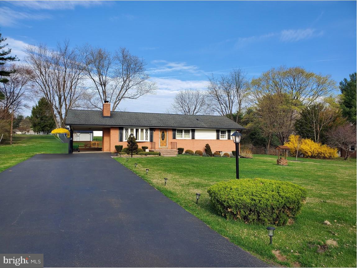 This property features a brand NEW WELL install July 2025 & a NEW A/C unit installed August 2025. Welcome to this charming rancher situated on an approx. 1.21-acre lot. As you enter, you're greeted by a large, inviting living room with a charming bow window that floods the space with natural light. The room boasts crown molding, gleaming hardwood floors, and an attached bookshelf unit that adds character and convenience. The dining room is complete with crown molding and hardwood floors with a door that leads to the carport for easy access. The sunroom adjacent to the dining room provides the perfect space to relax and opens to a deck for seamless indoor-outdoor living. The spacious eat-in kitchen offers lots of cabinetry, a double sink, & a tile backsplash - the ceiling fan light fixture adds comfort and style to this inviting space. The home offers three bedrooms, along with a full bath and a hall bath, providing convenience for all. The basement features a recreation room complete with a wood stove placed on a brick hearth pad – ideal for cozy nights & adding warmth to the home. Additional features include a laundry area with a large wash sink and a storage/utility room. Outside, the property offers an attached carport and a beautiful walkway leading to the front door. The expansive yard is perfect for outdoor activities, relaxation, and entertainment. The deck overlooks the grounds, while an oversized detached garage/shed is great for extra storage or workshop. The price reflects the home is in need of some updates & improvements, offering a great opportunity to add your own personal touches. This property is being sold “As-Is”.