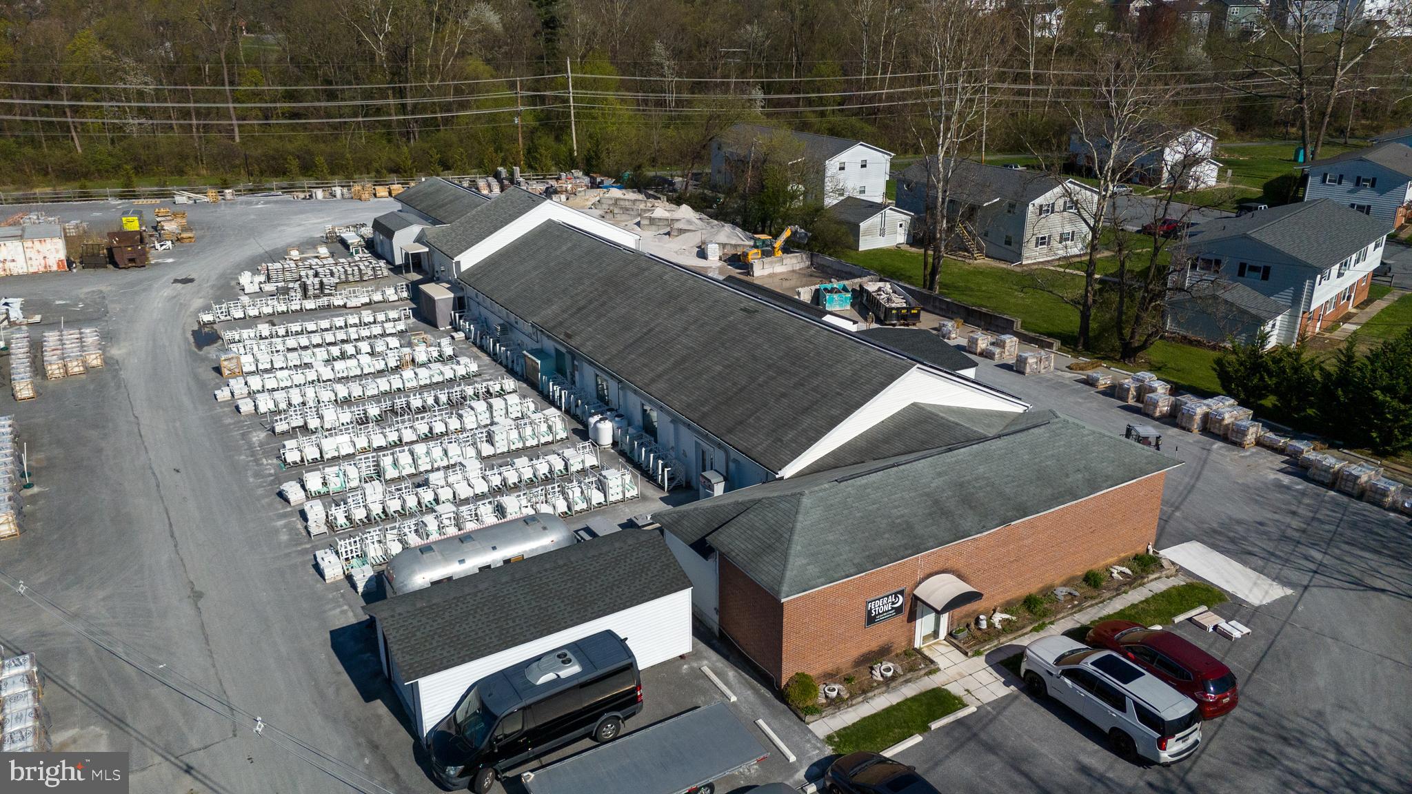 Manufacturing/industrial/warehouse building with outside storage. The Property includes 8,400 SF of space in two contiguous buildings located on a 3.8 acre lot. The front building includes 1,340 SF +/- of fully conditioned office space; and 5,360 SF +/- of heated warehouse space with 10’ clear ceiling height, radiant floor heat, and served by three drive-in doors. The rear building contains 1,690 SF manufacturing/warehouse space with 11’ clear ceiling height and a ceiling-mounted radiant strip heat. The property is served with 600 amp, three-phase electric service, and public water and sewer. Conveying with the property are 4 storage sheds totaling 1,760 SF +/-. This facility is a legal non-conforming use which may convey to the future owner; zoning is R-2 Town of Thurmont, Maryland. Thurmont is a business-friendly town and will allow a variety of uses on this property provided the new use is equal to, or less intense than the current use.