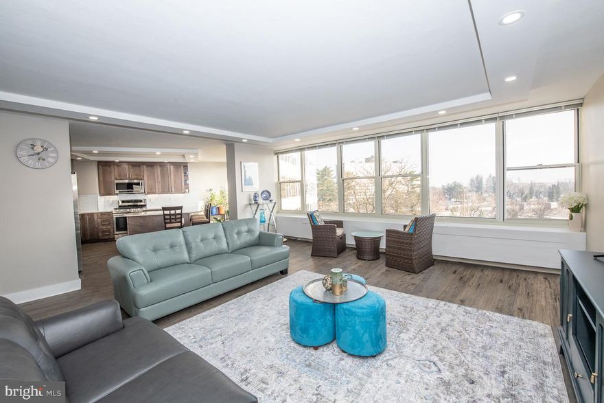 Welcome to Sutton Terrace, head to the 6th floor to experience a luxurious newly renovated condo with beautiful city skyline views, this is the new home you have been waiting for! The current owners have just completed this luxury renovation & reconfiguration making this unit like no other in the building! Enter and you are welcomed by a wall of windows streaming in sunlight spanning the rear of the home.  The entry hall has an ample coat closet and a newly renovated powder room. A Chef's eat-in kitchen with abundant new cabinetry, granite counters, sleek stainless appliances, gas cooking, modern glass tile backsplash, and a peninsula with seating for 6, with fantastic city views. The kitchen was moved from the interior corner to along the rear wall of windows to take advantage of the Center City skyline views.  The kitchen opens to a large open living space. The Owner's suite is large enough to accommodate a King-sized bed and a desk/workspace or a casual sitting area.  The sleek built-in closets line the hall to the en suite full bath and provide great storage.  The tiled full bath has an updated vanity and a combo soaking tub/shower. There is a generously sized den off of the entry foyer that can be used as a home office or second bedroom with a large walk-in closet/storage area with laundry room. Sutton Terrace is a maintenance-free luxury building with a 24hr doorman, Club Room available for large gatherings, an exercise room and a library on the first floor. Your monthly fee includes all of your utilities (except electric), there is a fee for plug-in electricity. The fantastic pool and tennis courts are $110 per season/ person.  There is available garage parking for $130/month which includes a weekly car wash! All of this just minutes to Center City, the Suburbs, Philadelphia International Airport and all major roadways.  Call for your appointment to see this showstopper today! Sutton Terrace limits showings due to Covid, no showings Saturday or Sunday.