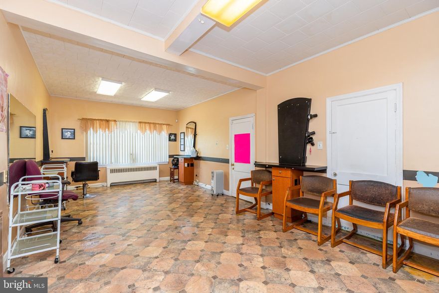 UNIQUE OPPORTUNITY TO OWN THIS 4 UNIT MIXED USE BUILDING IN HIGHLY VISIBLE LOCATION!   Main level with 2 separate commercial spaces - currently used a retail shop and the 2nd space is a salon.  Upper level with 2 residential units - 1 two bedroom unit and 1 one bedroom unit.  Ample off street parking, separately metered, and conveniently located close to 695 and I-70!  Endless possibilities!  Monthly rental income of $2,650!