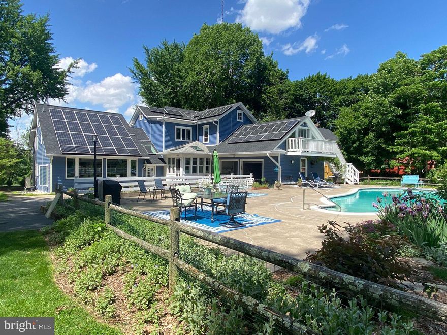 Welcome to this warm and inviting home, designed for both entertaining and relaxation. Dive into the expansive 20x40 concrete swimming pool, conveniently heated by your own solar panels. Nestled on nearly 2 acres of stunning perennial gardens, this residence boasts over 300 plant species, offering a serene and beautiful outdoor escape.

Perched high on College Hill, this exceptional property features breathtaking sunset views and seamlessly integrates classic colonial design with a contemporary addition, providing versatile living and entertaining spaces. The impressive great room features vaulted ceilings, skylights, and a spiral staircase, creating a bright, airy atmosphere. A wet bar and formal dining area enhance the setting, perfect for memorable gatherings.

The updated kitchen is a chef's dream, featuring quartz countertops, stainless steel appliances, new wall ovens, a cooktop, and a cozy breakfast nook. The finished lower level offers a flexible recreation room equipped with a pool table and a full bath, ensuring plenty of space for relaxation and fun. Elegant hardwood floors and intricate moldings throughout the home add to its timeless charm.

The inviting living room, centered around a wood-burning fireplace, serves as a warm focal point. Upstairs, the primary suite includes a spacious walk-in closet, a bonus room, and a private balcony overlooking the solar-heated pool.

Additional highlights include a gardener’s workshop with a deck, a two-car garage, ample parking, owned solar panels, and a brand-new roof. Mini-splits provide efficient heating with an oil-fired hot-water backup.

Conveniently located just minutes from Lafayette College, Starbucks, Giant Food, award-winning restaurants, The State Theater, and a bus station to NYC, this home offers an easy commute to New York City, making it an ideal weekend getaway or full-time residence.