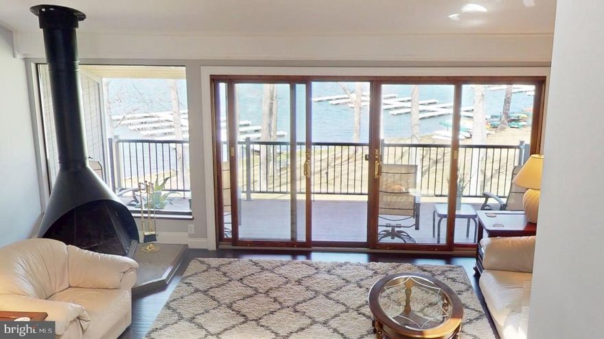 Pack your bags and escape to your move in ready condo located at Four Hooppole South, nestled in peaceful mountain Maryland in one of the most coveted coves of Four-Season Deep Creek Lake.    Enjoy breathtaking views from the deck of your stunning, lakefront, 3+ bedroom, 2 bath condo or cozy up to the free-standing wood fireplace in your spacious livingroom.    Condo boasts many upgrades including:  Carrier mini splits (installed in 2021 and warranted until 10/2031) that supply AC and heat throughout the condo and can be remotely controlled so your condo is at the perfect temperature upon your arrival; all upgraded Pella windows and doors; black stainless appliances and quartz countertops in kitchen; bathrooms updated with ceramic tile and granite countertops;  wood flooring throughout most of the condo.  The enclosed patio entry area includes two outdoor storage closets.   The lakeside offers not only one but two outdoors areas for eating, relaxing or watching the sunrise and set.   Upper deck updated with composite deck boards.  Large lower patio  with extended composite area,   Amenities include private boat slip (located only steps from your condo), boat ramp, sandy beach with swim dock, sports court, lake side volleyball court, community log cabin, and children's play area,   Four Hooppole South consists of 10 acres of pristine grounds with year-round  maintenance staff for worry-free ownership,  Also included is Cable TV, property-wide WiFi, trash removal and paved parking.  All of this and only minutes from restaurants, grocery, skiing, snow tubing, hiking, and many other activities.      Make your appointment for a tour today!
